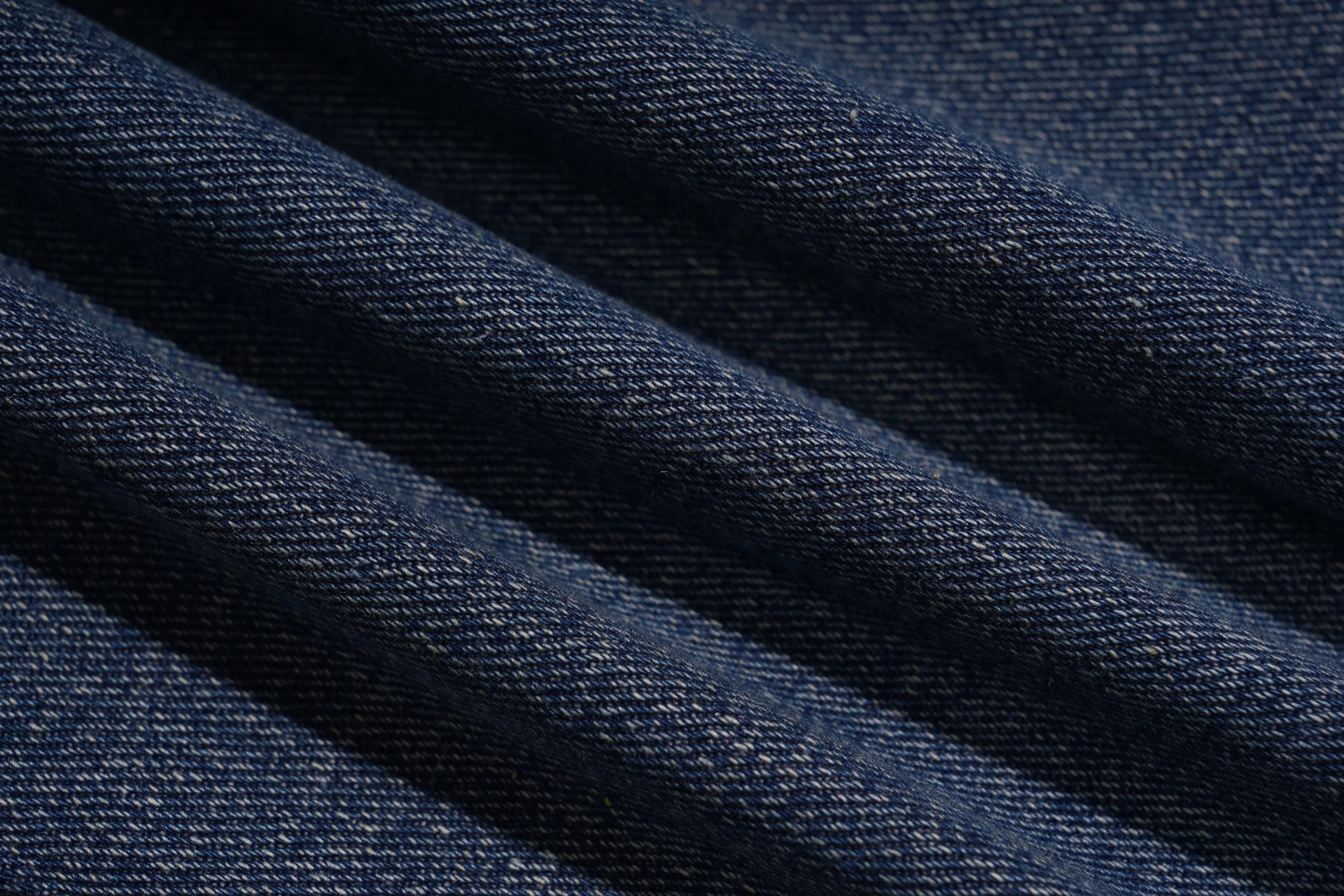Close-up of dark blue denim fabric with visible texture, TCH Rhinestone Butterfly & Lily Distressed Denim Jeans