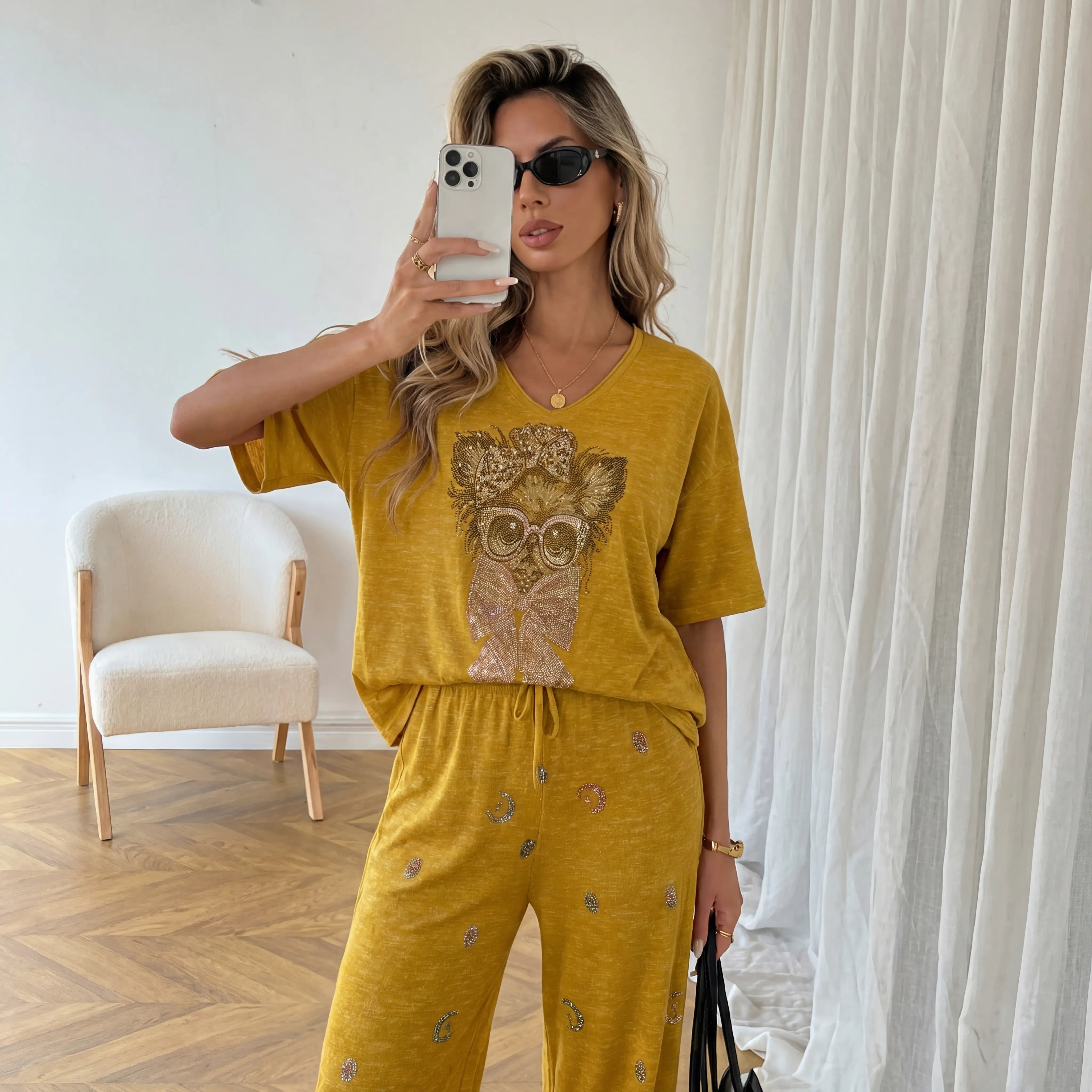 Woman taking a mirror selfie wearing a mustard yellow outfit with an owl design. TCH Rhinestone Chihuahua Galaxy Set