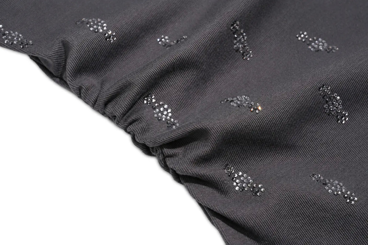 Close-up of a dark gray ribbed fabric with small scattered rhinestone embellishments, shown against a white background. TCH Rhinestone Cross Graphic Fitted Long Sleeve Top