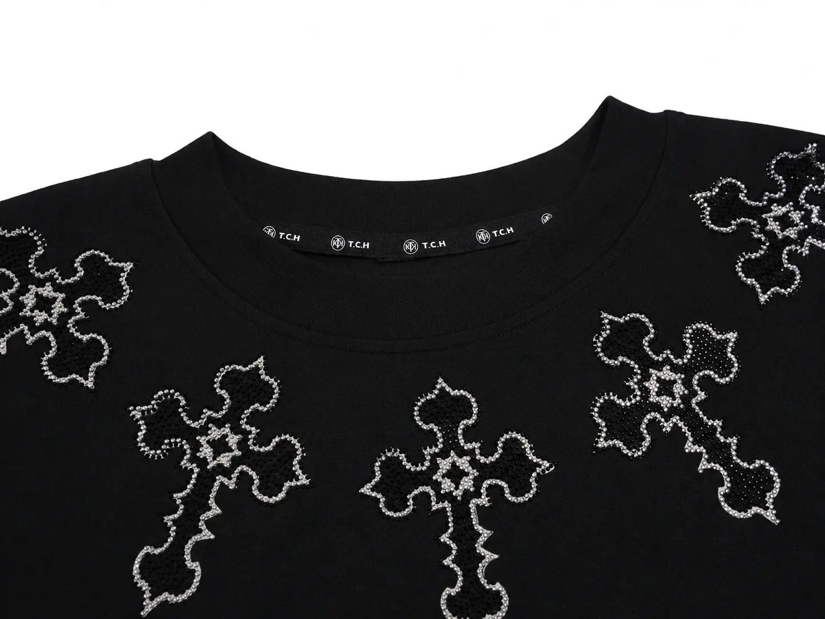 Close-up of a black crewneck sweatshirt featuring silver rhinestone-embellished cross and star patterns on the front, with a visible TCM brand label inside the collar. TCH Rhinestone Cross Pattern Black Long Sleeve T-Shirt