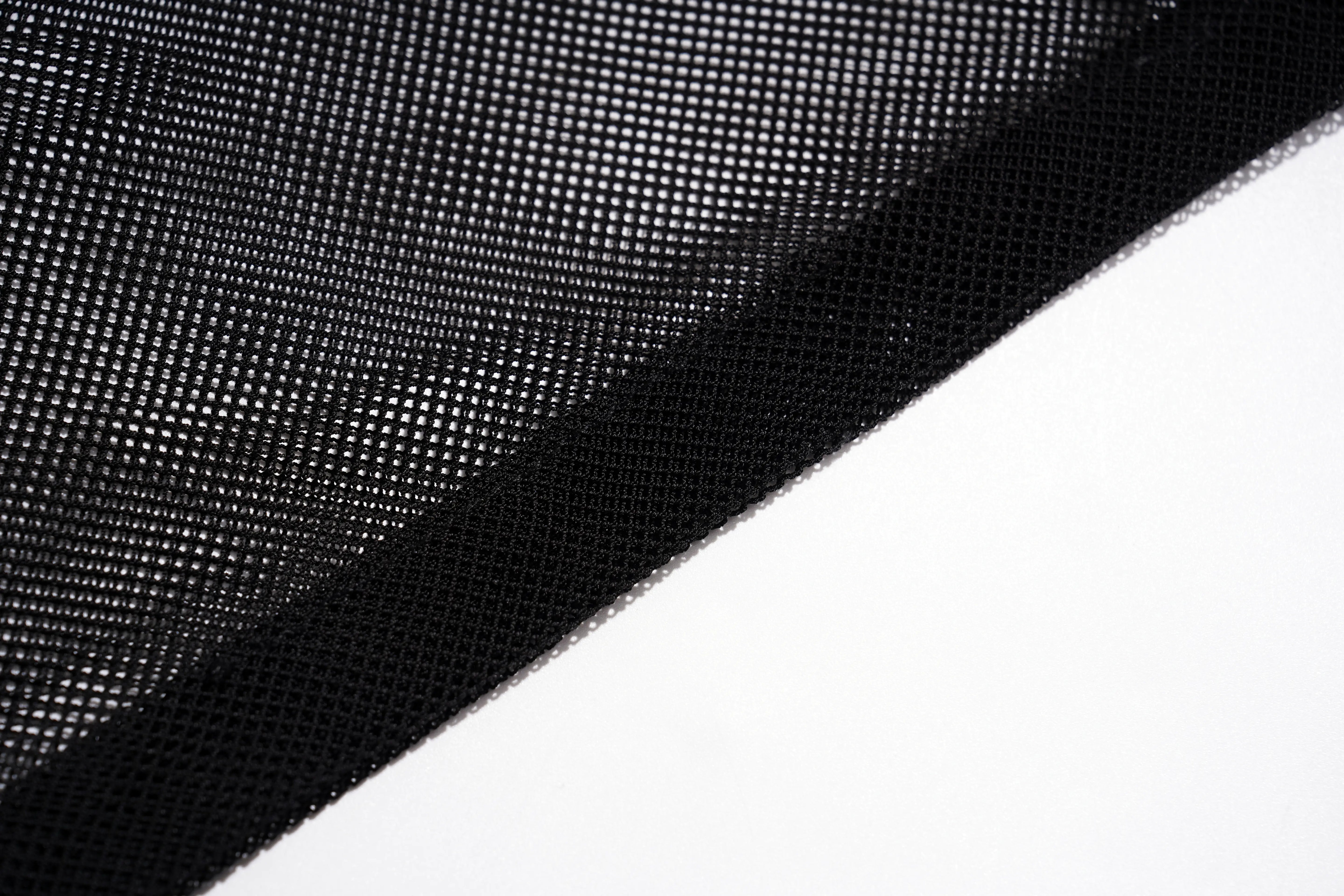 Black mesh fabric with a fine grid pattern, folded diagonally over a plain white background. TCH Rhinestone Deer Graphic Mesh Sleeve Black Streetwear T-Shirt