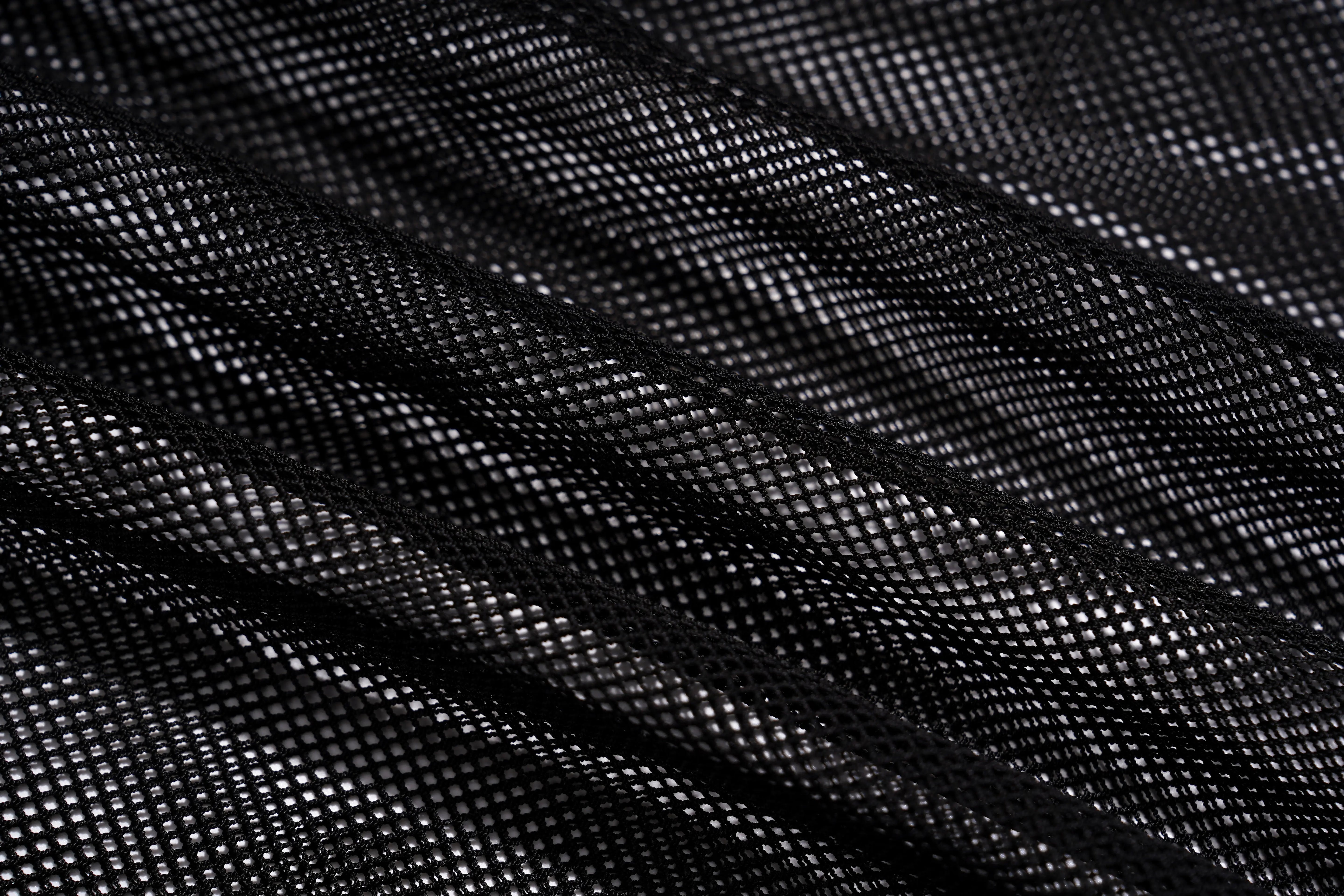 Close-up of black mesh fabric with a fine woven grid texture and soft diagonal folds. TCH Rhinestone Deer Graphic Mesh Sleeve Black Streetwear T-Shirt