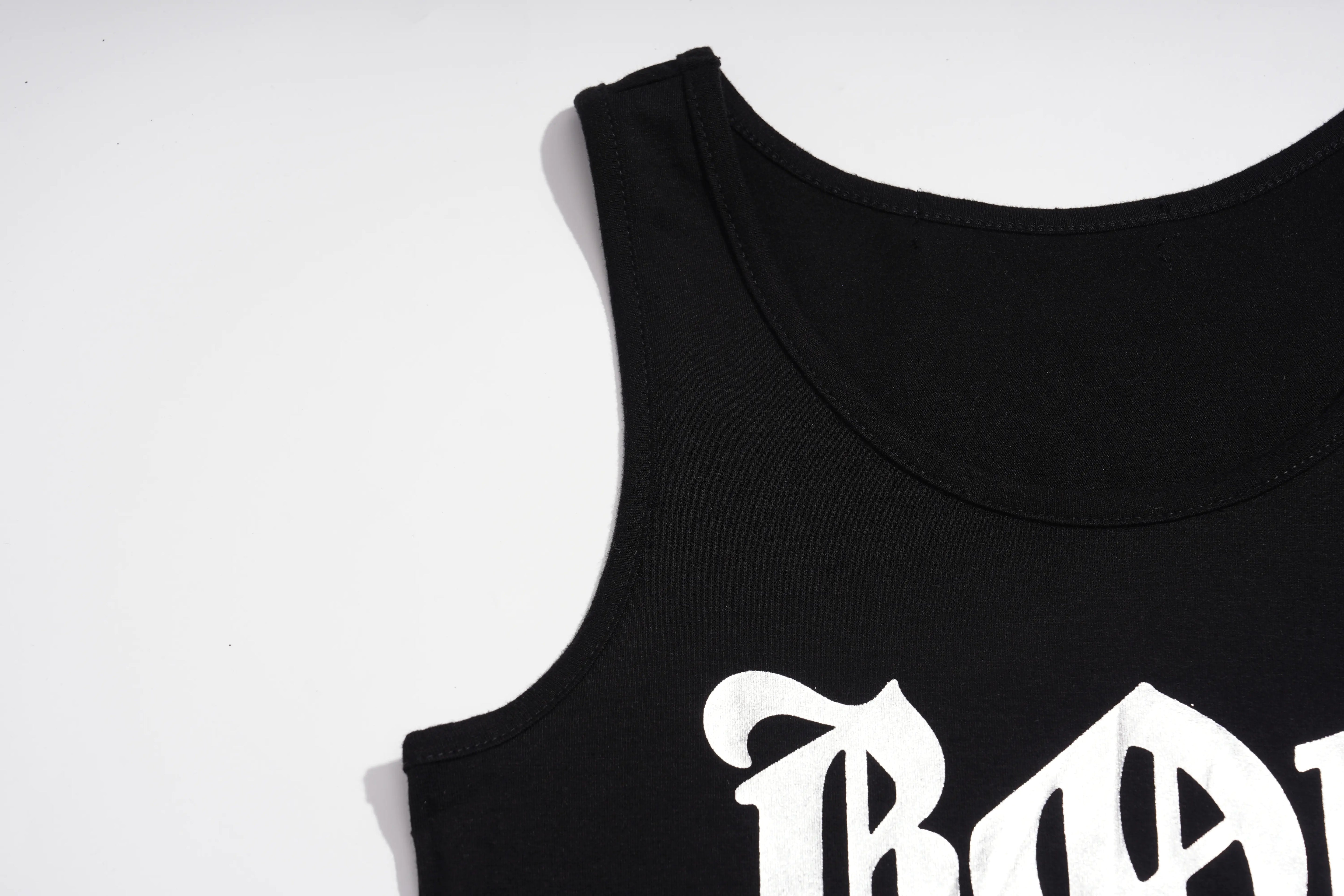 Close-up of a black sleeveless tank top with a white Gothic-style letter graphic on the front, photographed against a plain white background. TCH Rhinestone Deer Graphic Mesh Sleeve Black Streetwear T-Shirt
