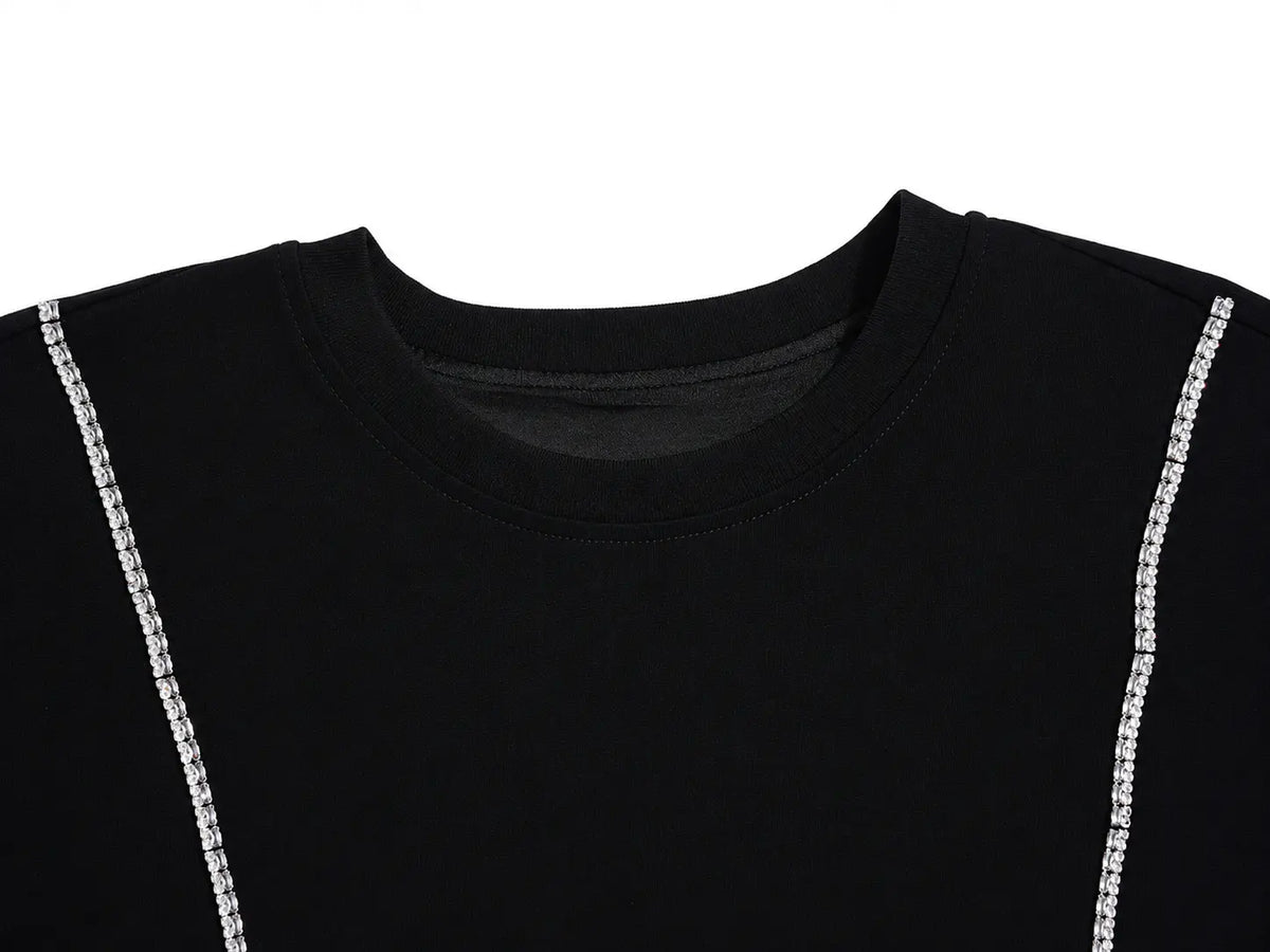 Close-up of a black crewneck t-shirt featuring decorative silver chain embellishments running down the sides of the shoulders, set against a plain white background. TCH Rhinestone Denim Corset Graphic Oversized T-Shirt