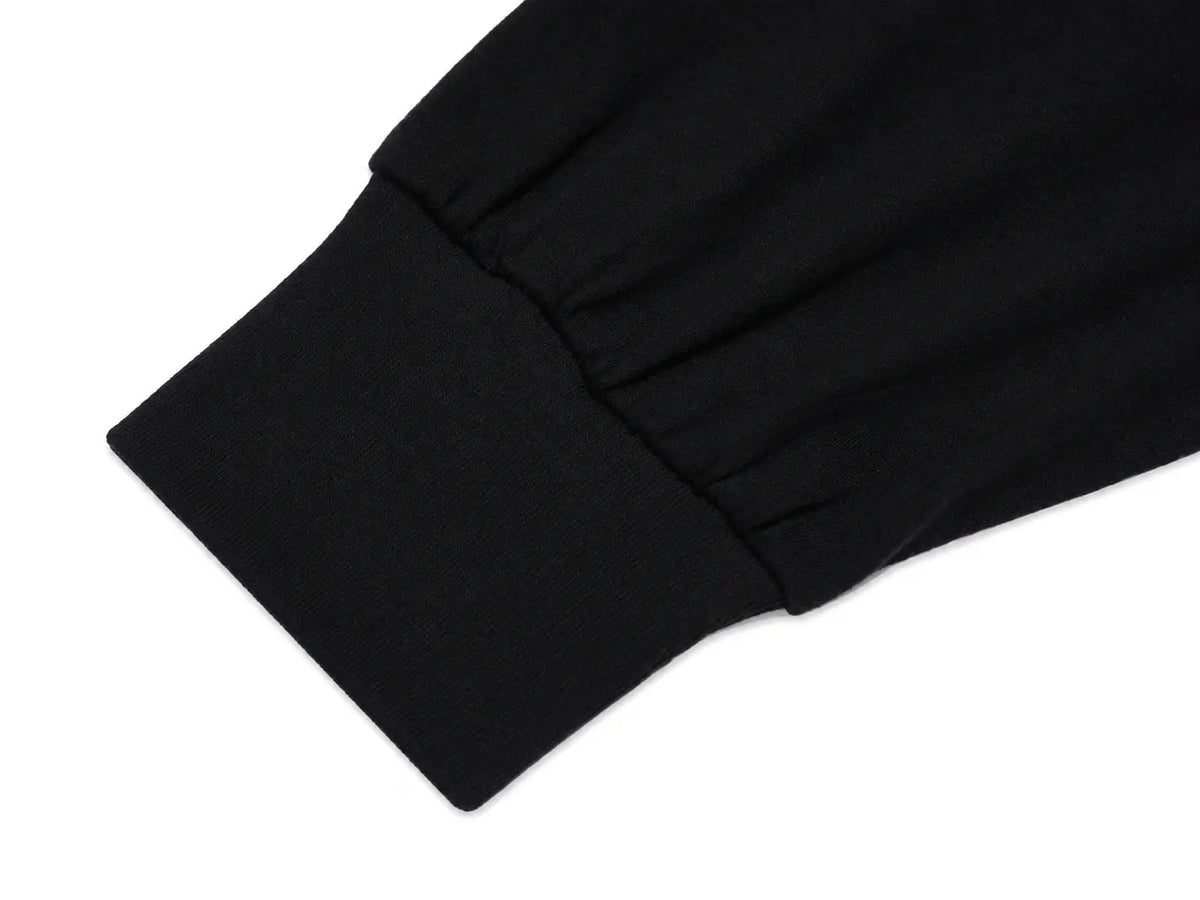 Close-up detail of a black fabric garment showing a gathered cuff and pleated sleeve construction on a white background. TCH Rhinestone Firework Graphic Black Sweatshirt