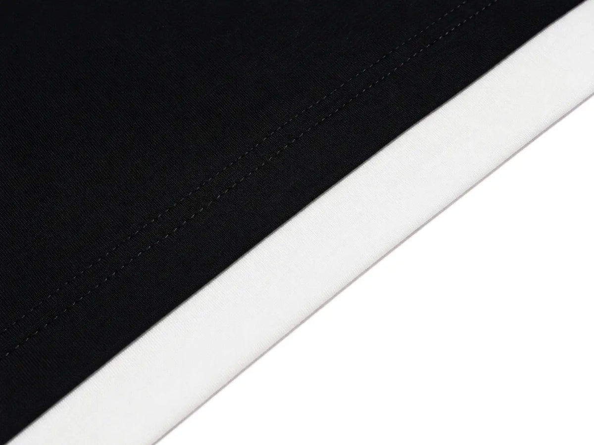 Close-up detail of a black fabric item with a wide white stitched border on a white background. TCH Rhinestone Firework Graphic Black Sweatshirt