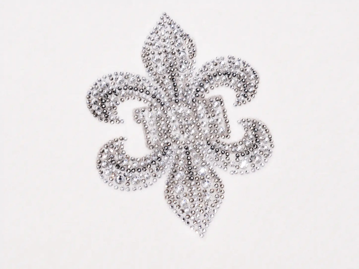 A silver fleur-de-lis embellished with rhinestones, shown on a plain white background. TCH Rhinestone Fleur-de-Lis Fitted Long Sleeve Top