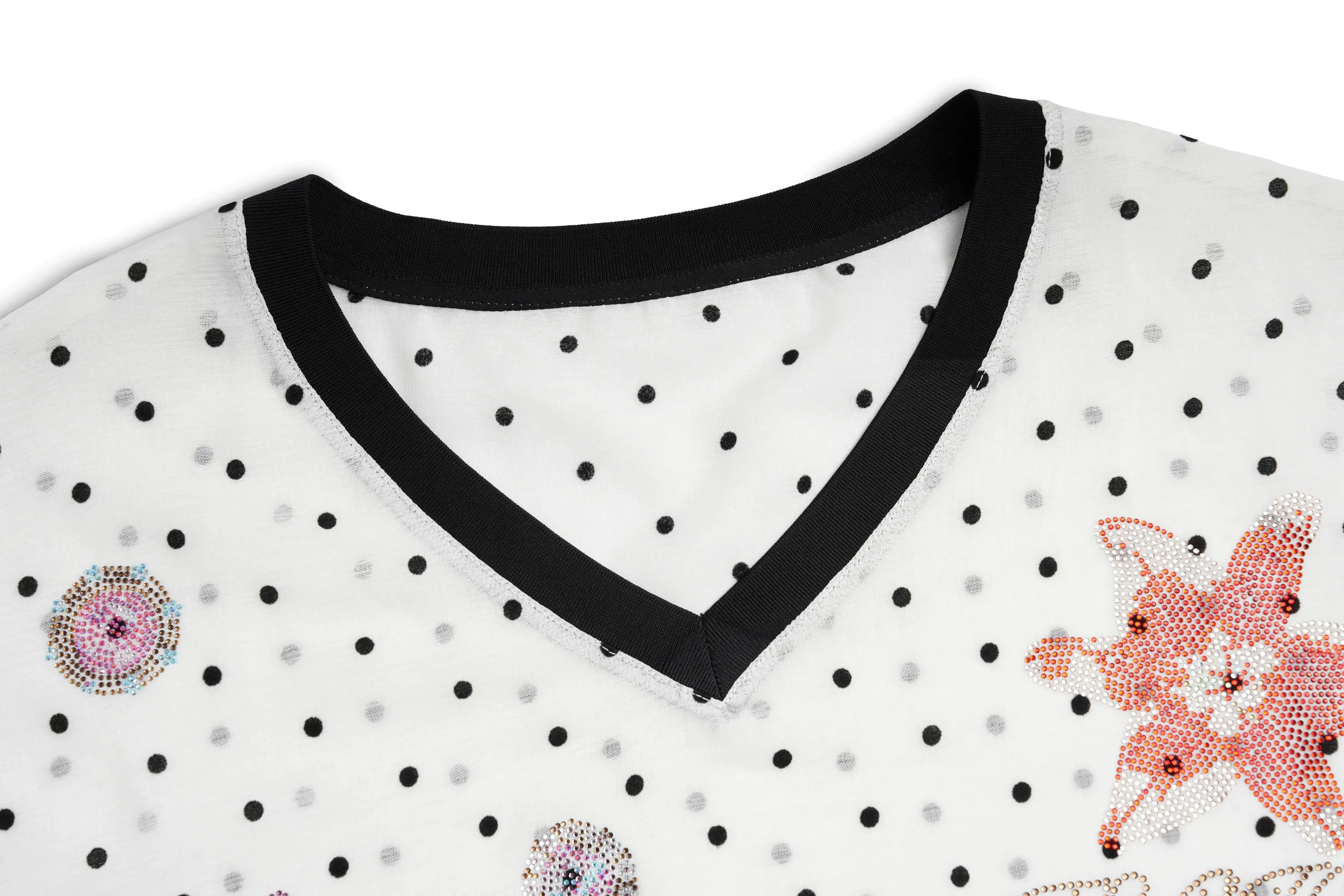 Close-up of a polka dot shirt with floral and rhinestone details on a white background, TCH Rhinestone Floral Garden Polka Dot Long Sleeve Top