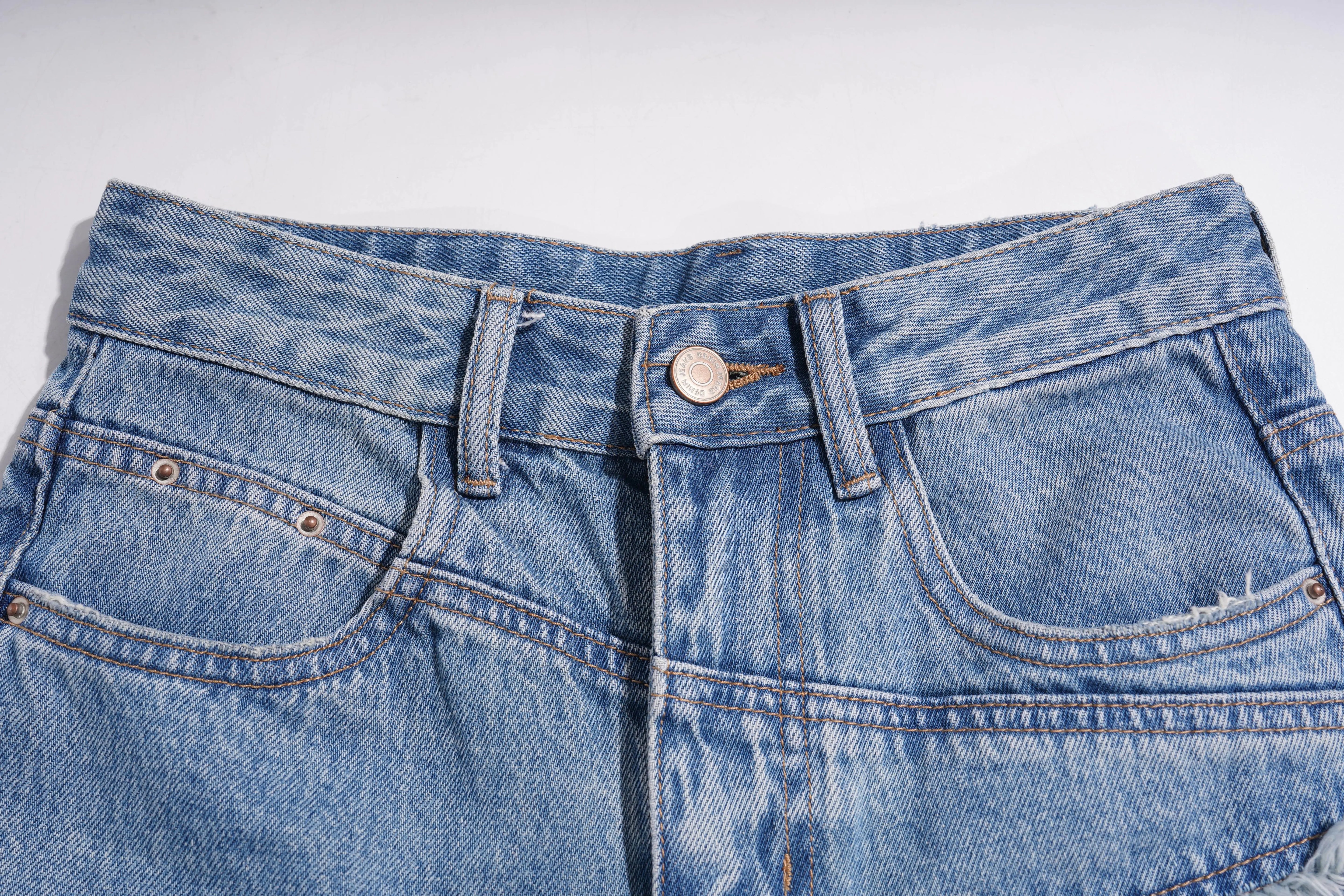 Close-up of blue denim jeans with a white background, TCH Rhinestone Floral Wide-Leg Blue Jeans