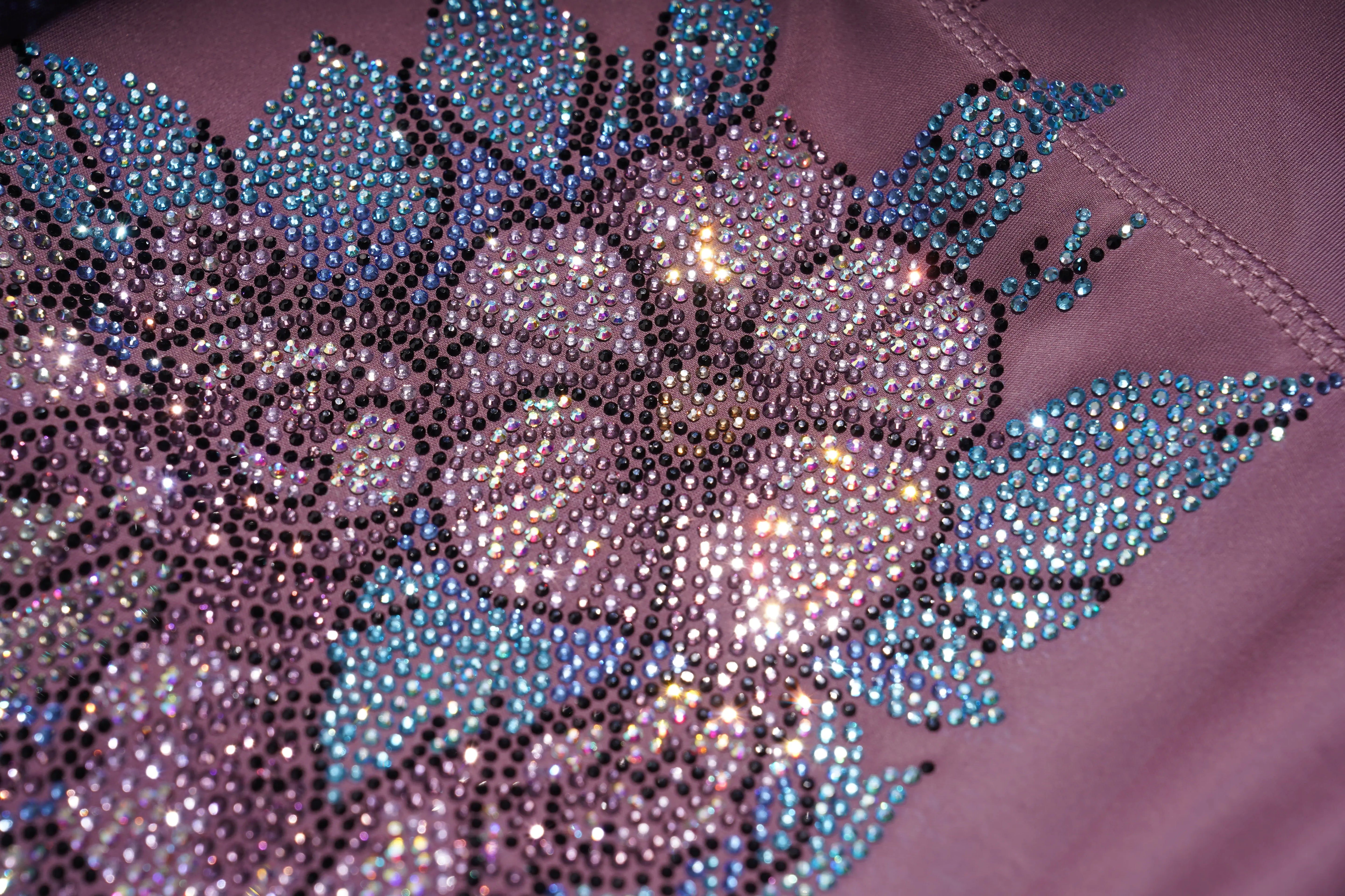 Close-up of a floral embellishment with rhinestones on a fabric surface. TCH Rhinestone Floral Wing High-Waist Leggings-11