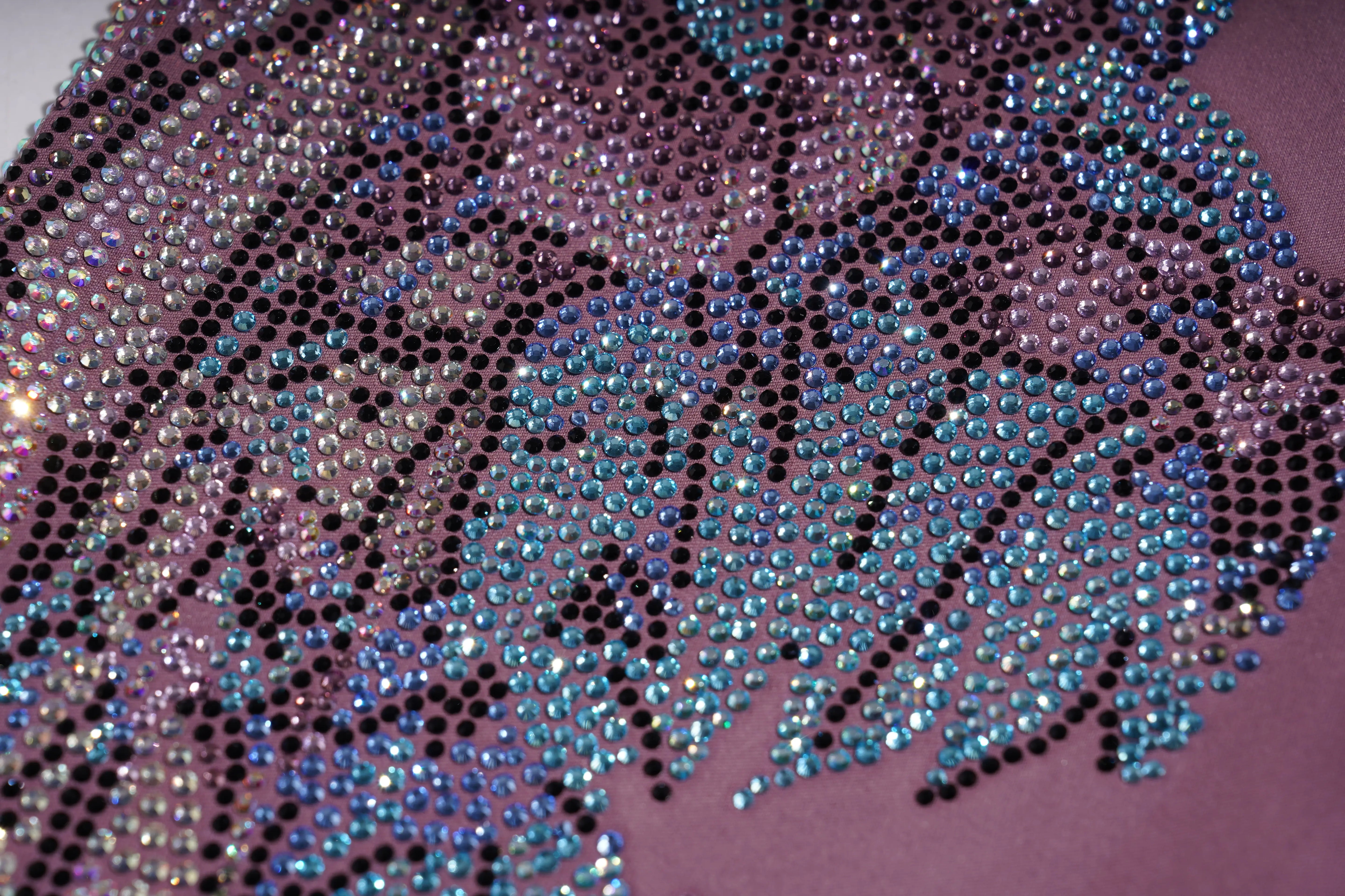 Close-up of a fabric with sequin pattern on a purple background, TCH Rhinestone Floral Wing High-Waist Leggings