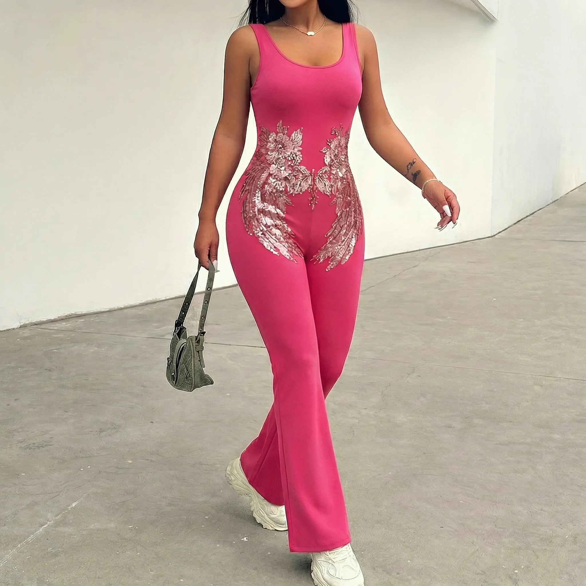Person wearing a pink jumpsuit with floral embroidery on a plain background. TCH Rhinestone Floral Wing Yoga Jumpsuit-1