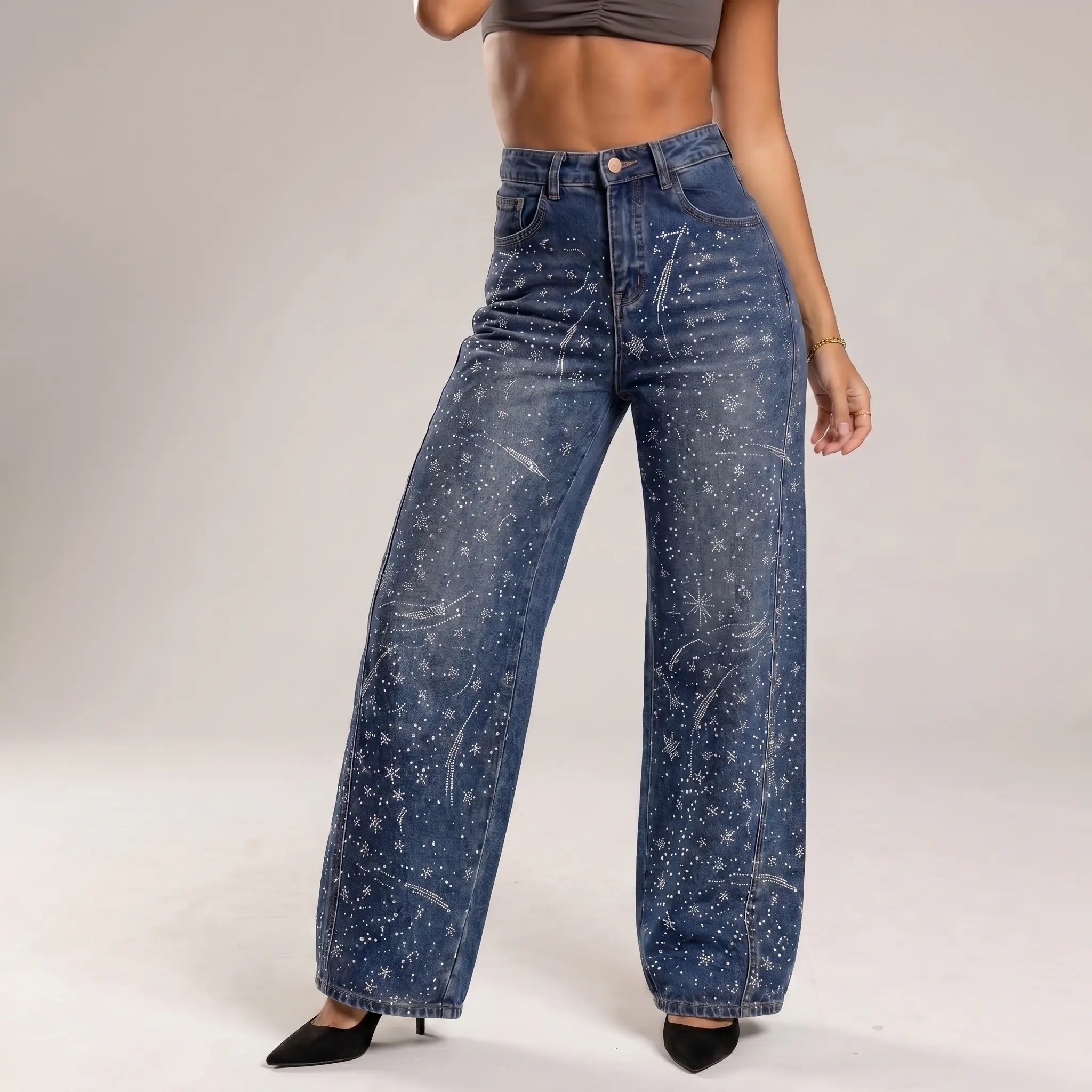 Person wearing blue jeans with star patterns on a plain background, TCH Rhinestone Galaxy Sparkle Wide-Leg Jeans