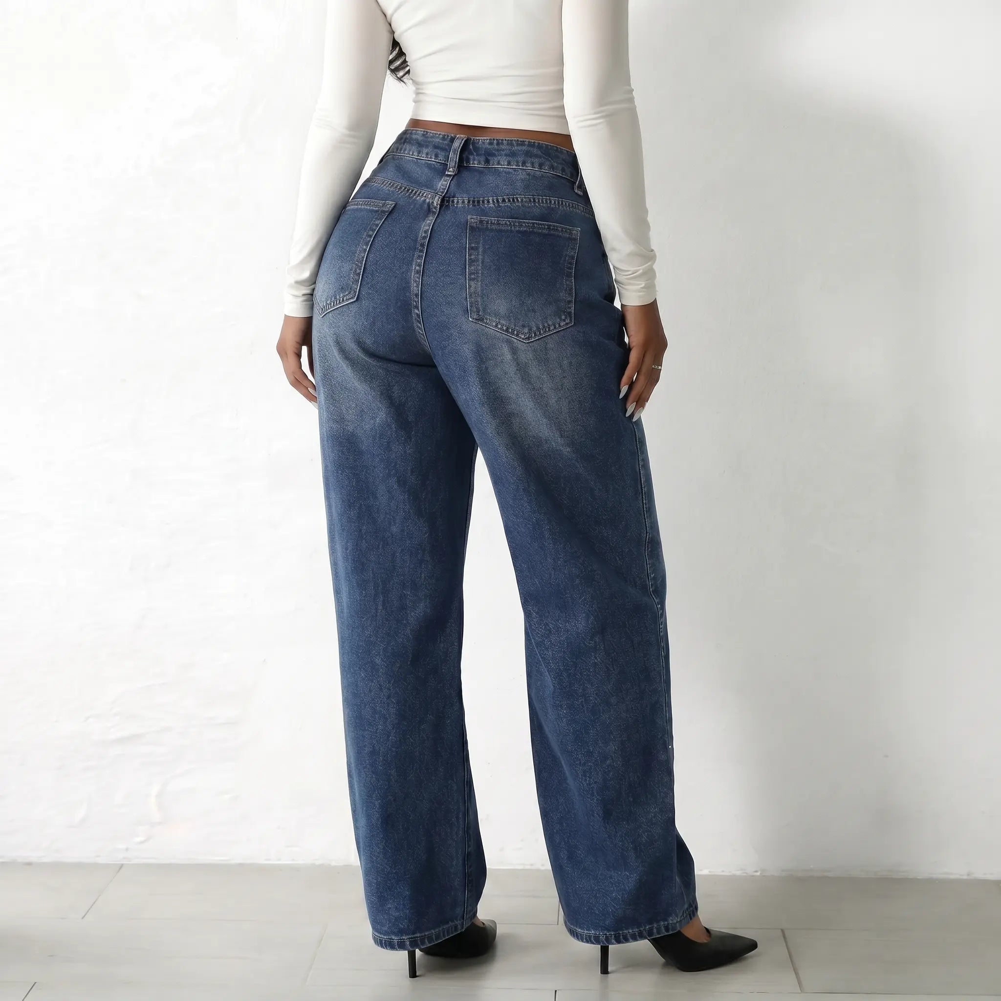 Person wearing blue jeans and a white long-sleeve top on a plain background, TCH Rhinestone Galaxy Sparkle Wide-Leg Jeans