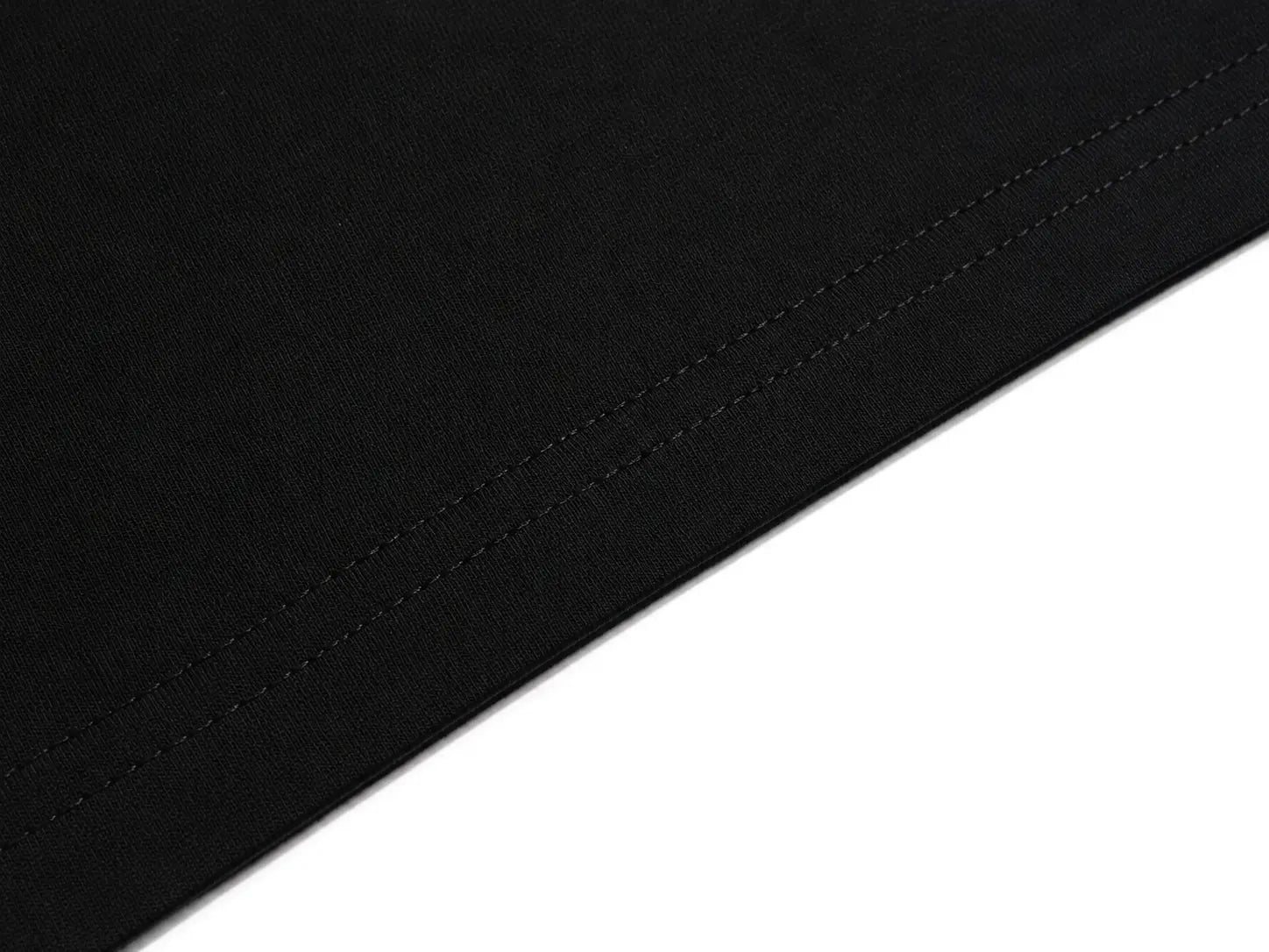 Close-up of a black fabric surface with a diagonal stitched seam against a white background. TCH Rhinestone Galaxy Spiral Graphic Black T-Shirt