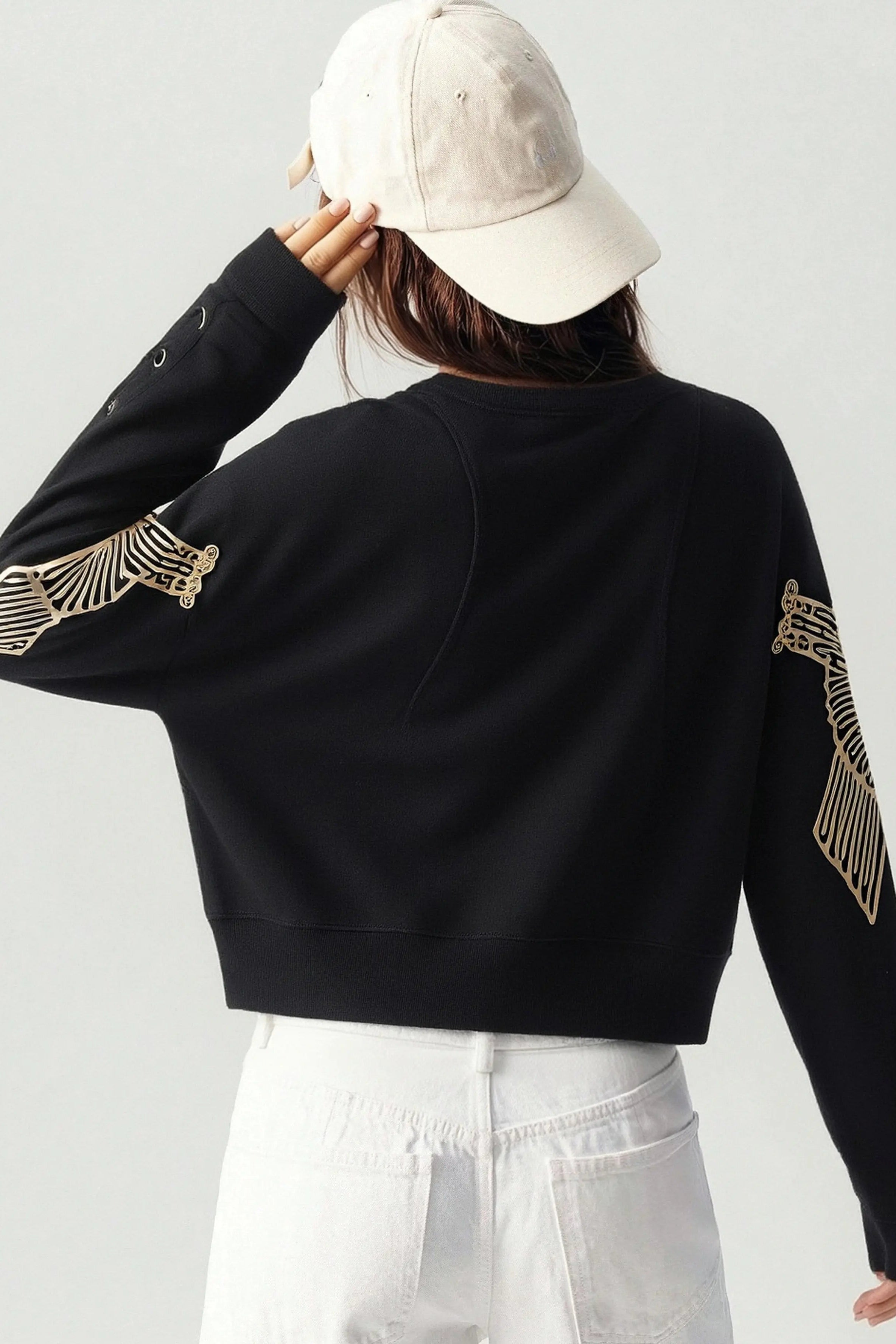 Person wearing a black sweatshirt with gold designs on sleeves against a white background, TCH Rhinestone Girl & Dog Graphic Crewneck Sweatshirt