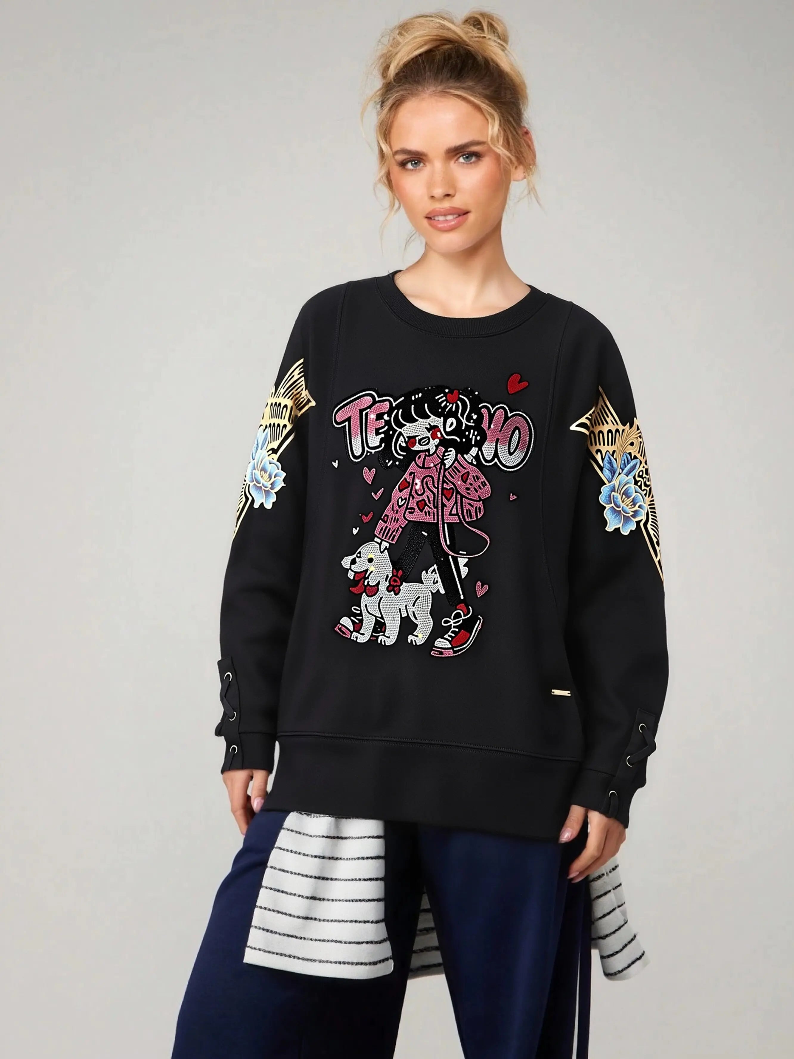 Woman wearing a black sweatshirt with colorful graphics and text on a gray background, TCH Rhinestone Girl & Dog Graphic Crewneck Sweatshirt