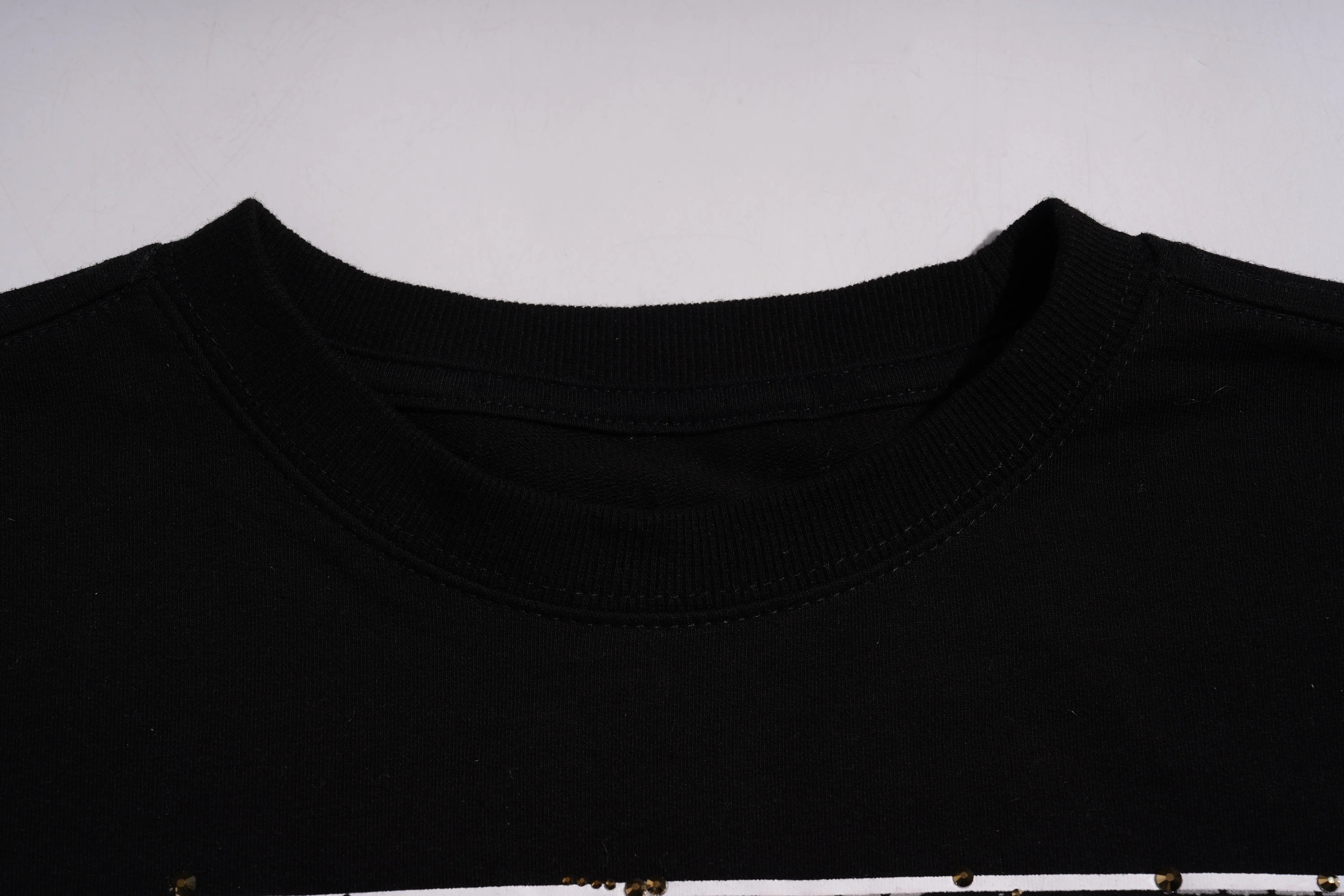 Close-up of a black t-shirt against a gray background, TCH Rhinestone Gold Dragon Poster Sweatshirt