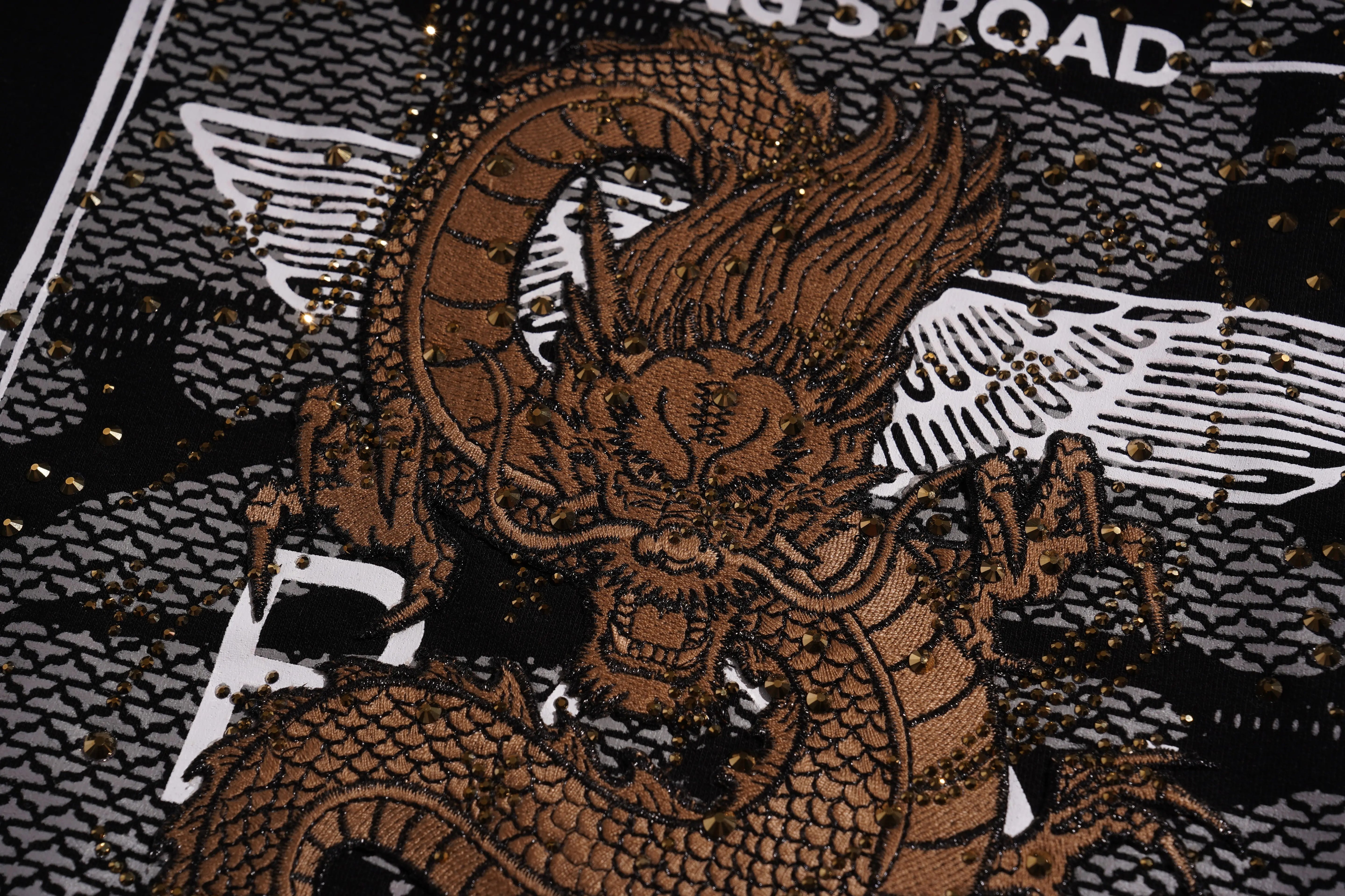 Dragon design on a textured surface with 'King's Road' branding. TCH Rhinestone Gold Dragon Poster Sweatshirt