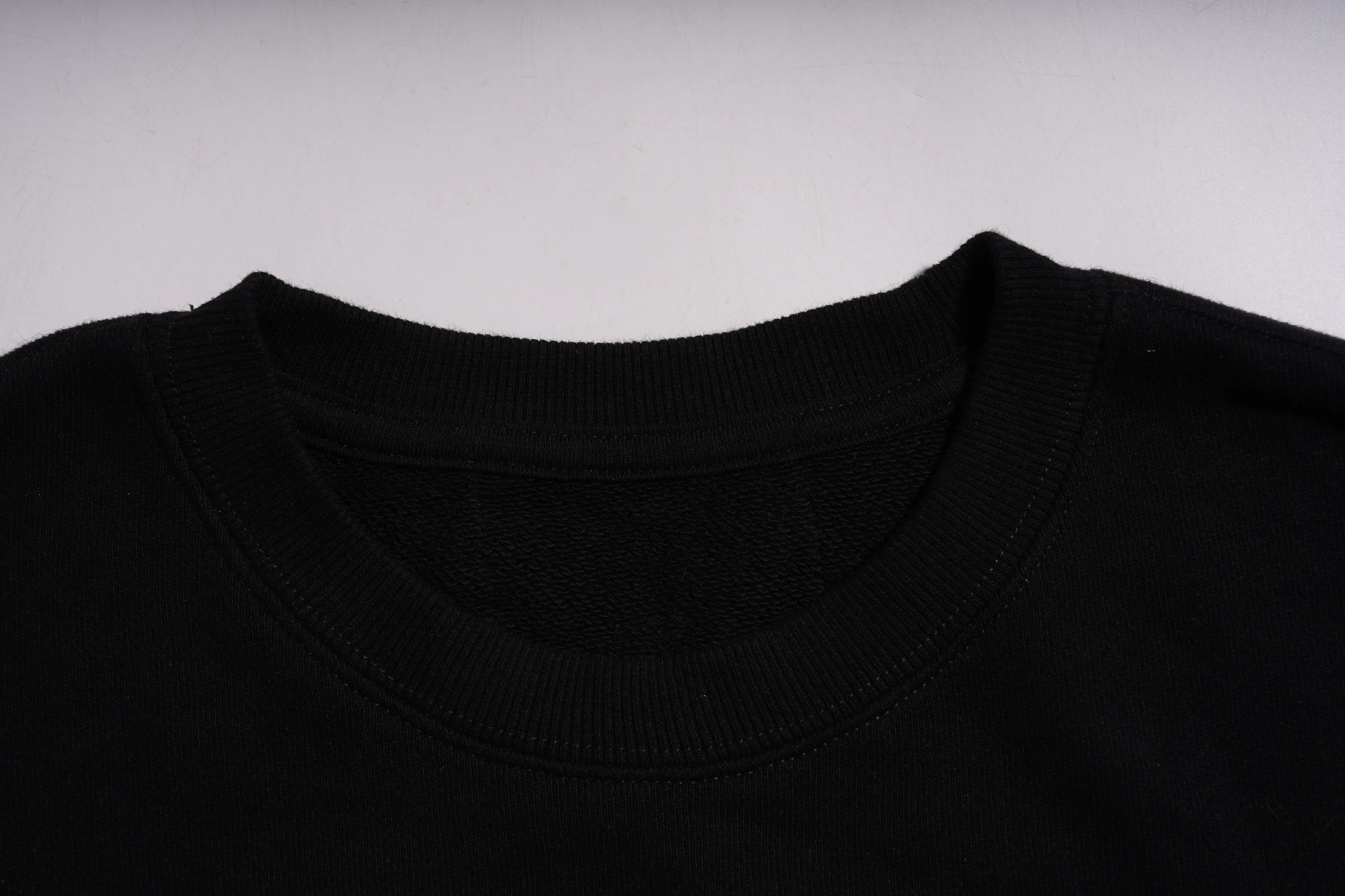 Close-up of a black shirt collar on a light gray background, TCH Rhinestone Gradient Star Leopard Sweatshirt