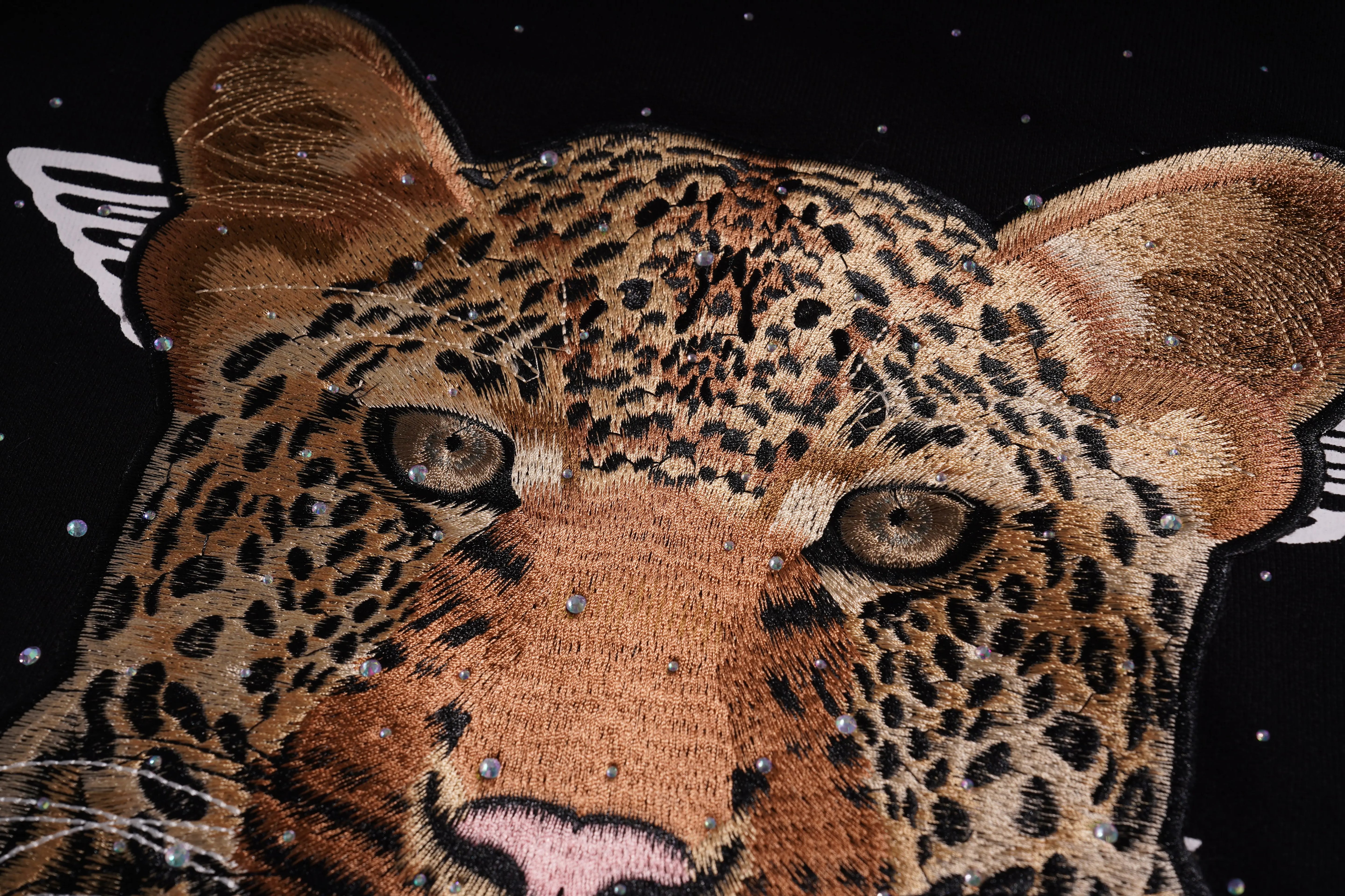 Embroidered patch of a leopard face on a black background, TCH Rhinestone Gradient Star Leopard Sweatshirt