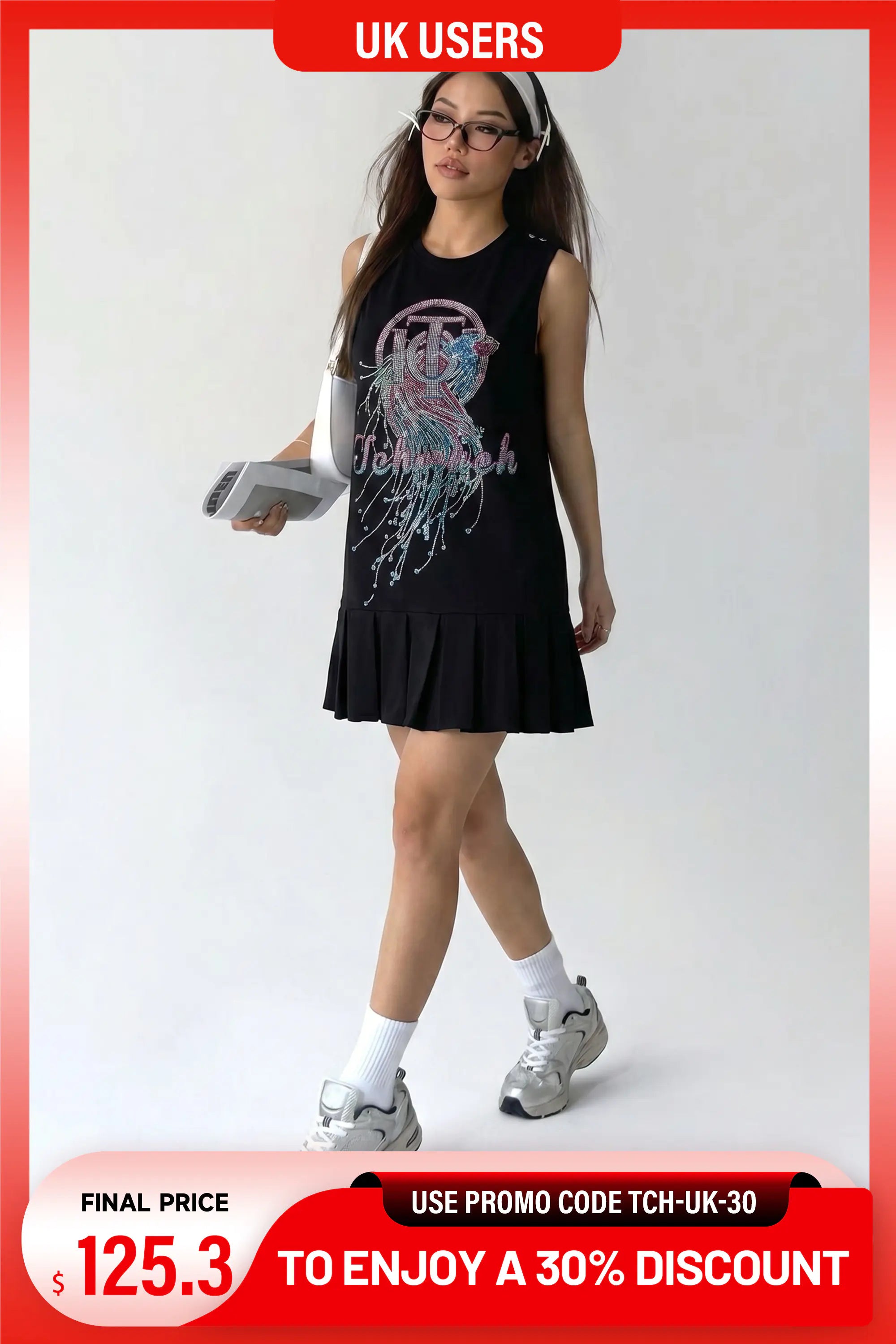 A woman modeling a sleeveless black pleated mini dress with a colorful graphic print on the front, styled with white socks and silver sneakers, set against a plain light background with promotional text overlays. TCH Rhinestone Graphic Pleated Hem Sleeveless Black Dress