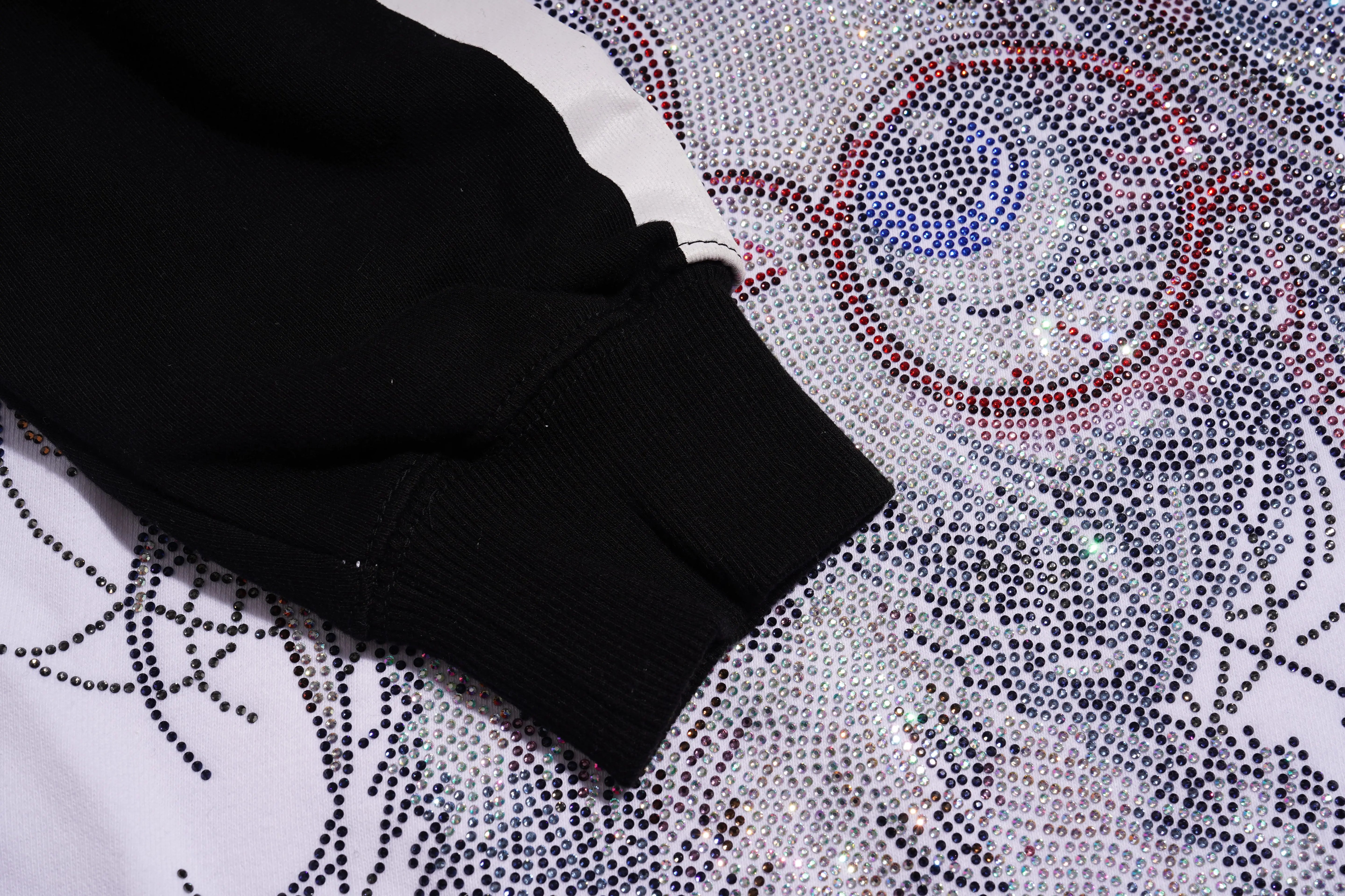 Black sleeve on a white surface with decorative patterns, TCH Rhinestone Hello Kitty BOYLONDON Sweatshirt