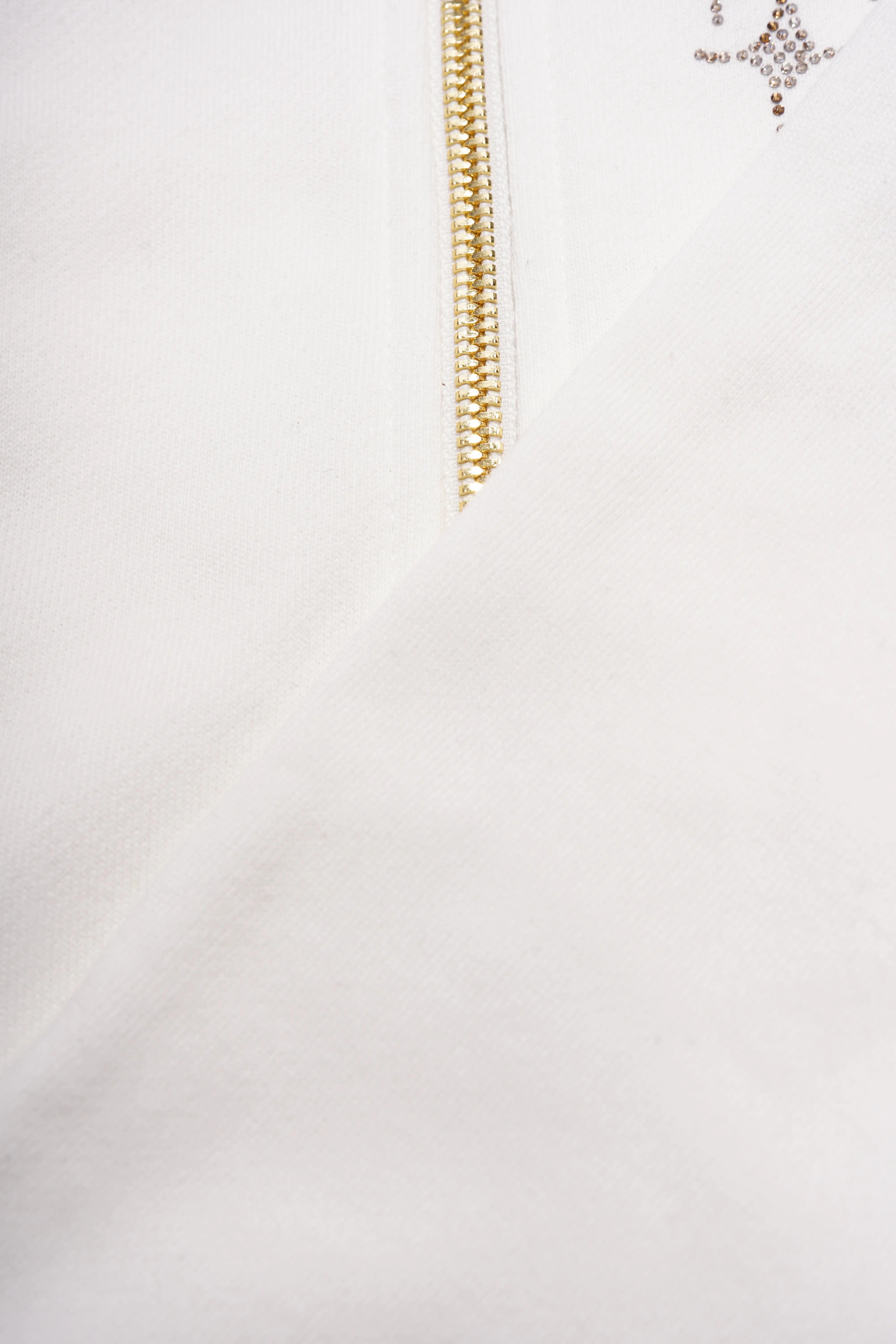 Close-up of a white garment with a gold chain detail on a white background, TCH Rhinestone Horse Graphic Jacket