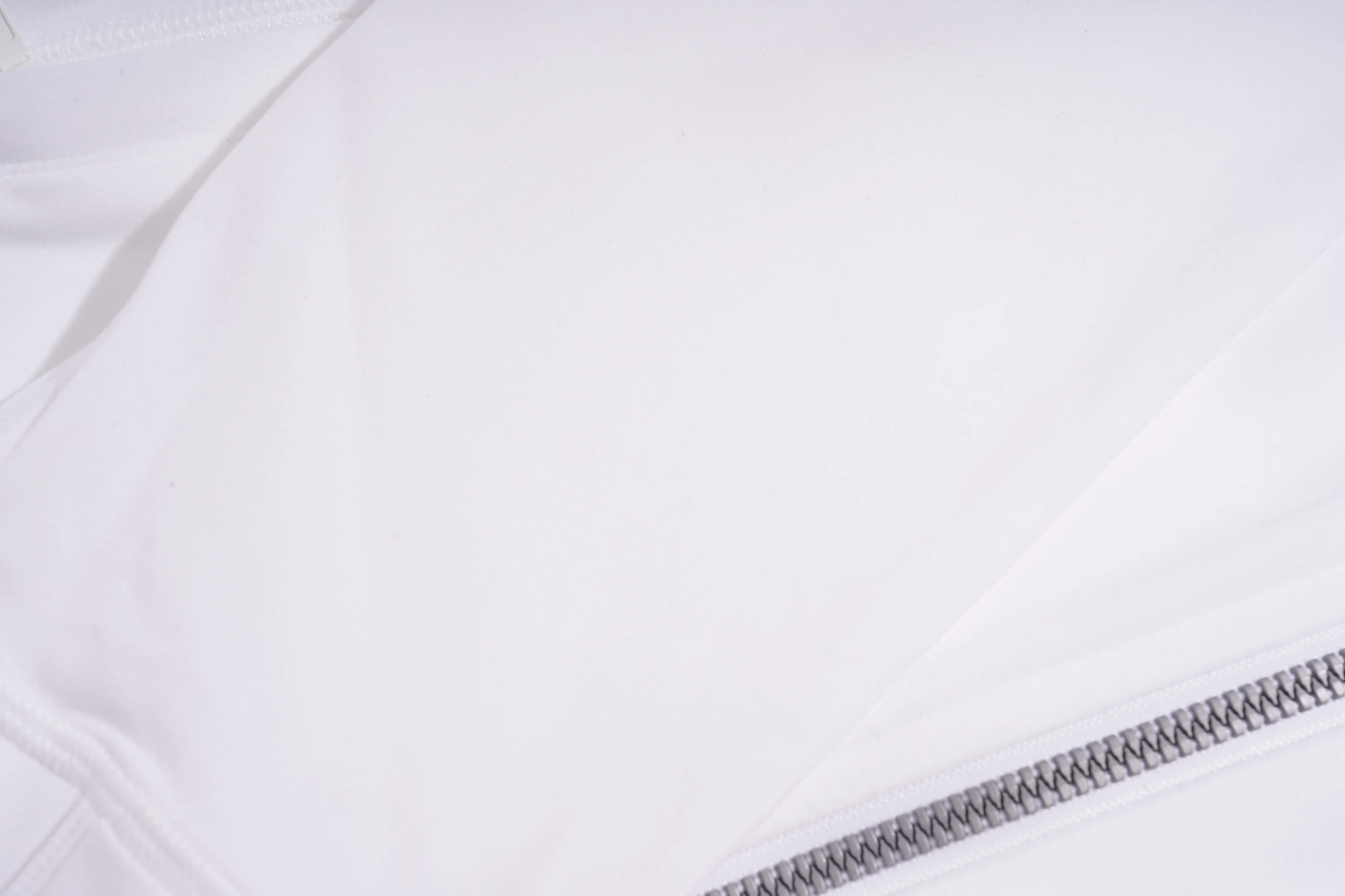 Close-up of a white jacket with a zipper on a light gray background, TCH Rhinestone Lion & Horse Head Hoodie