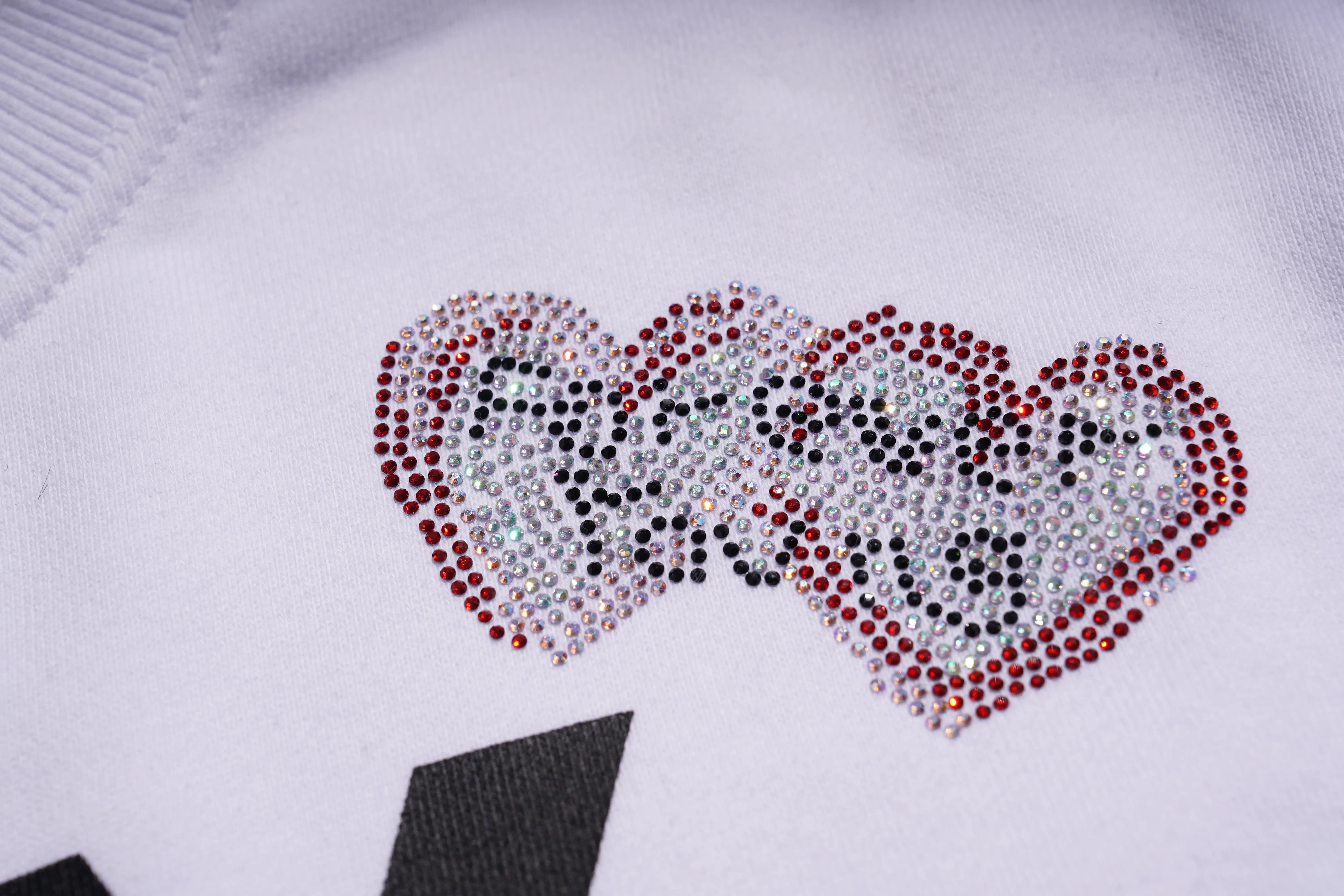 Heart-shaped design made of rhinestones on a white background. TCH Rhinestone Logo Print Crew Neck Sweatshirt