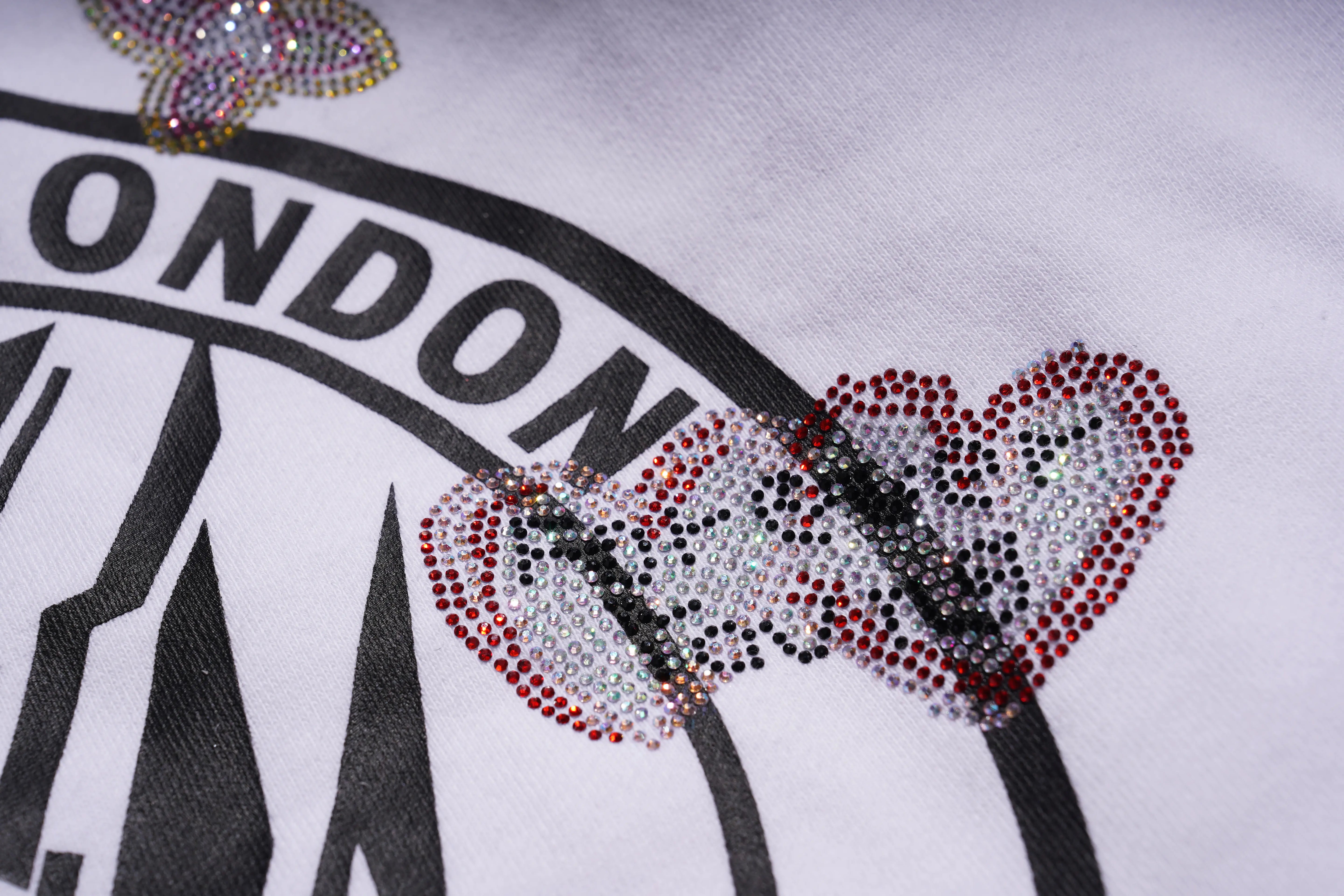 Text 'LONDON' with decorative hearts on a white background, TCH Rhinestone Logo Print Crew Neck Sweatshirt