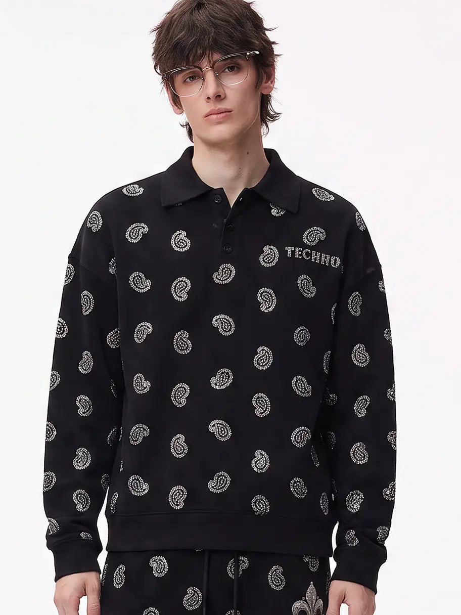 A model wearing a light blue denim jacket with various embroidered patches, including a teddy bear on the left chest and cherries on the sleeve, styled over a white t-shirt and dark pants. TCH Rhinestone Paisley Pattern Long Sleeve Polo Shirt