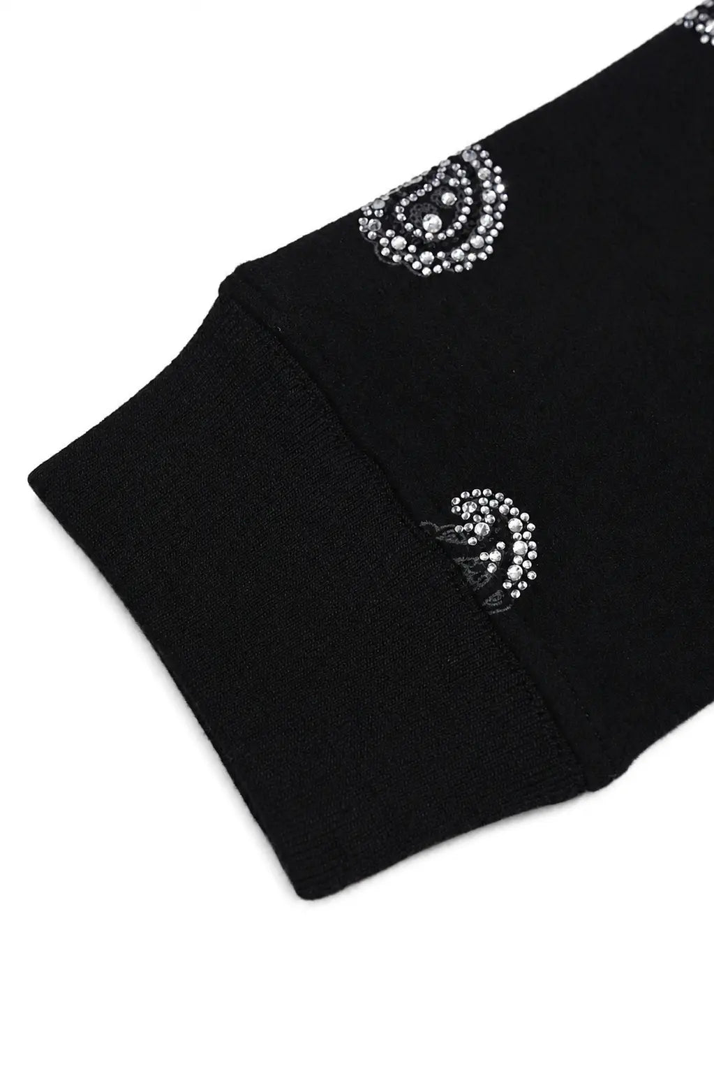 Close-up of a black knit garment cuff with two circular silver rhinestone embellishments on a white background. TCH Rhinestone Paisley Pattern Long Sleeve Polo Shirt