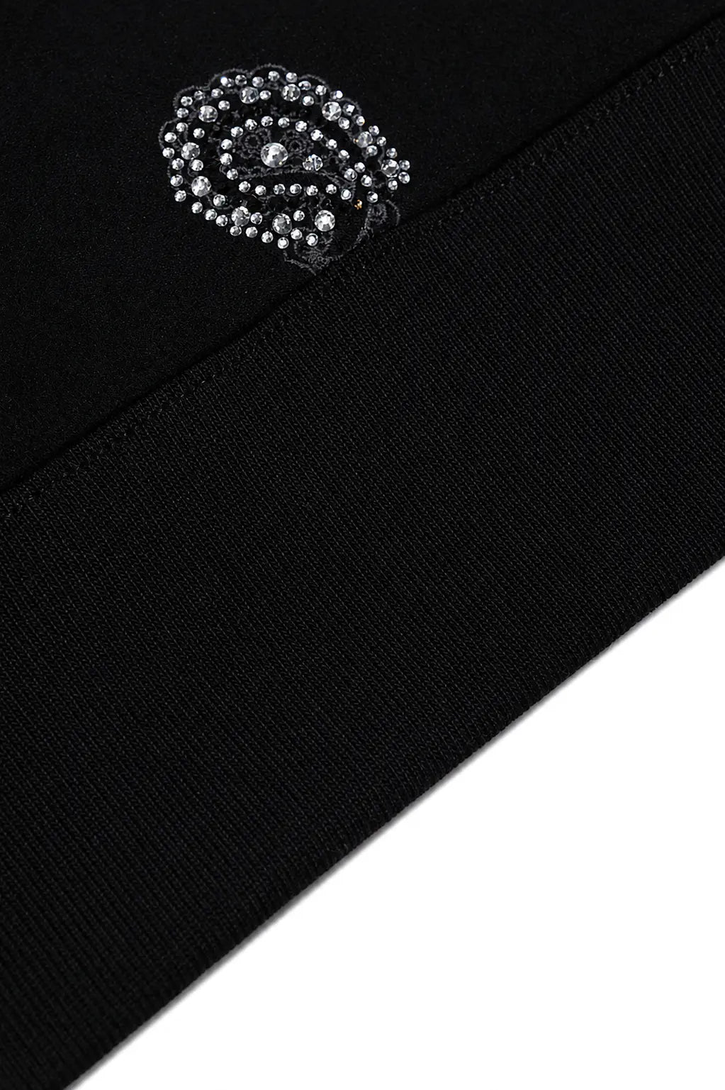 Close-up of a black knit garment featuring a decorative silver-toned rhinestone brooch near the shoulder seam. TCH Rhinestone Paisley Pattern Long Sleeve Polo Shirt
