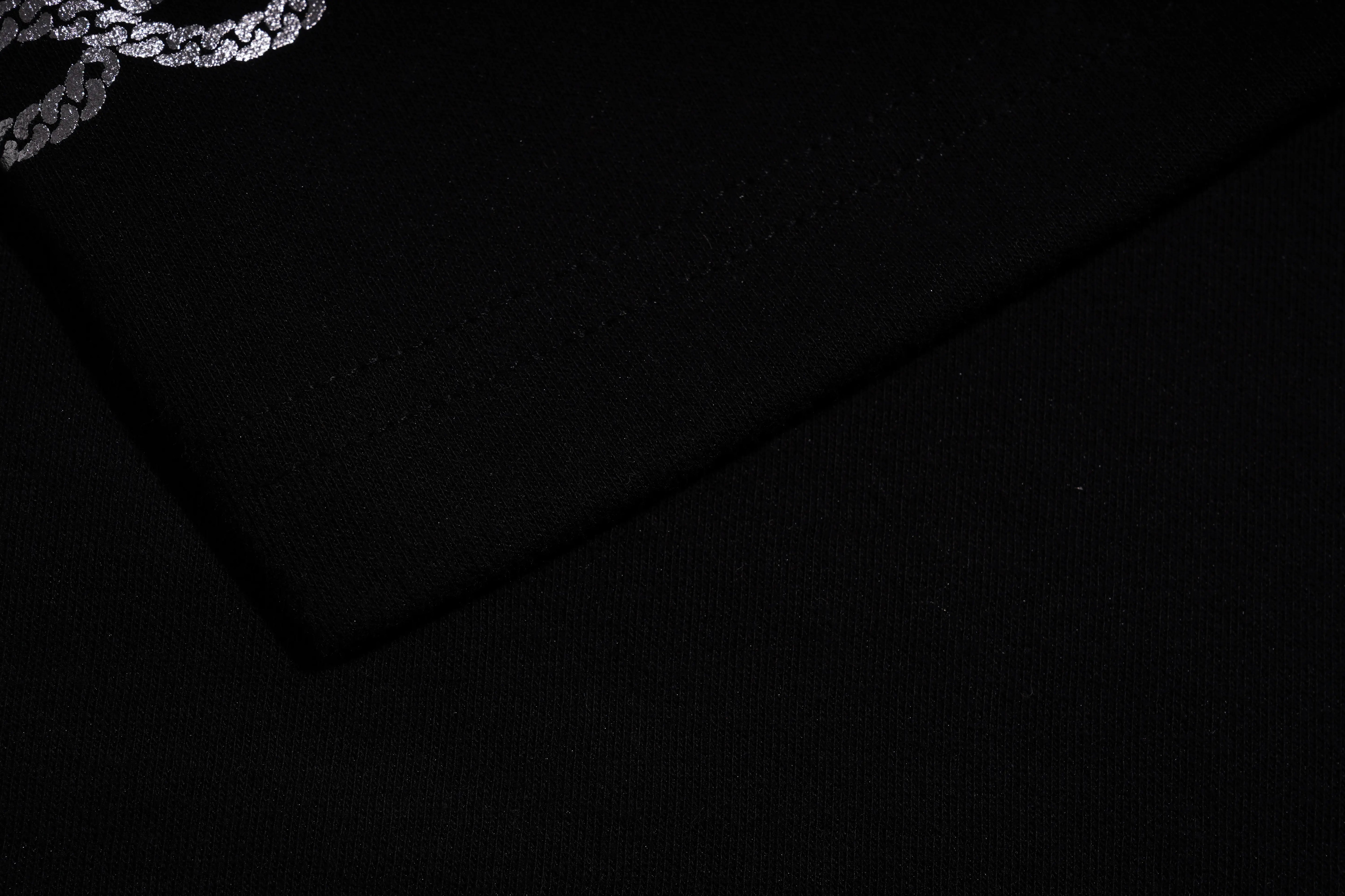 Close-up of black fabric with a subtle pattern on a dark background, TCH Rhinestone Panda Bow Dress