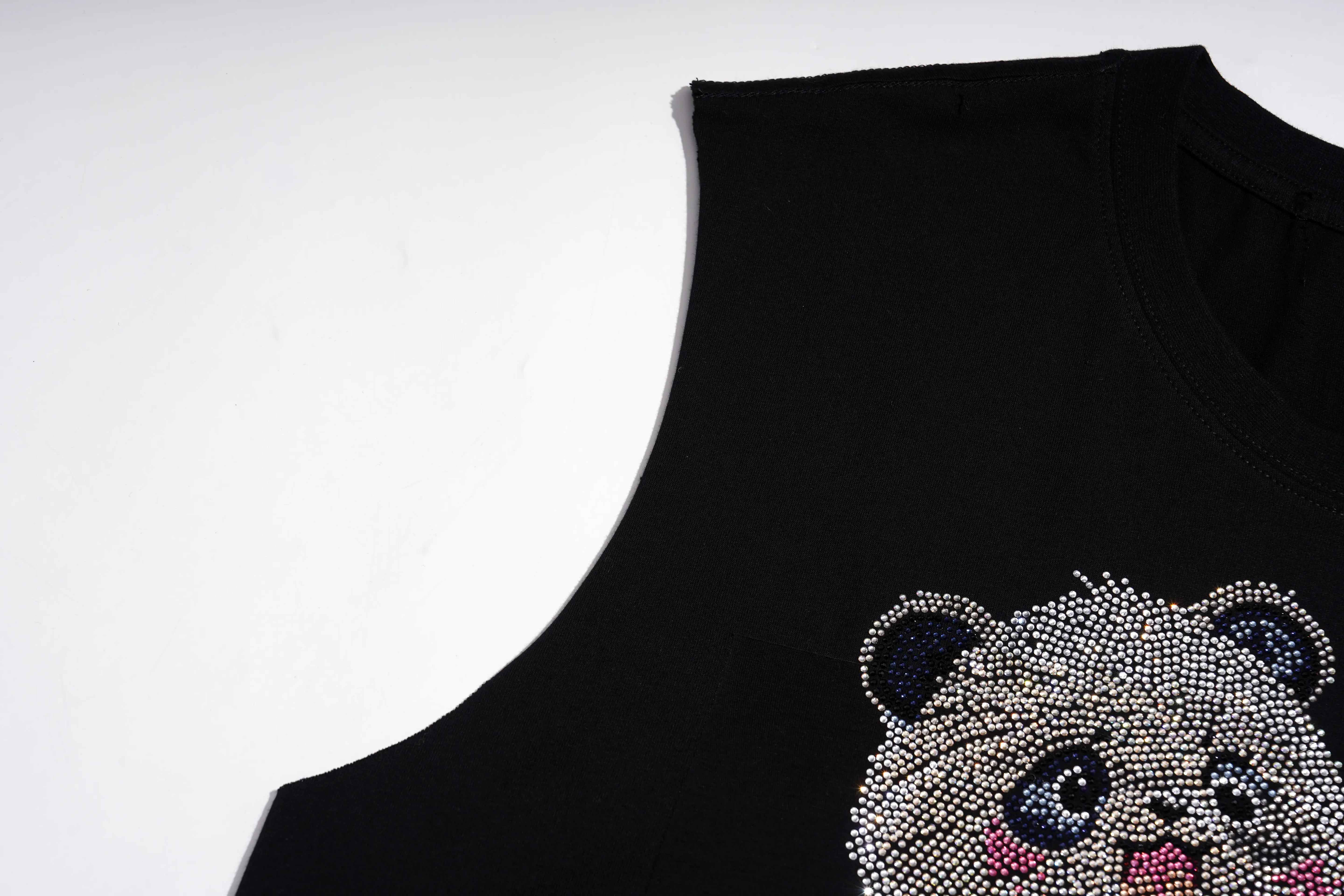 A close-up of a black sleeveless top featuring a large, detailed cartoon bear face embellished with sparkling rhinestones on the front, set against a plain white background. TCH Rhinestone Panda Graphic Sleeveless T-Shirt