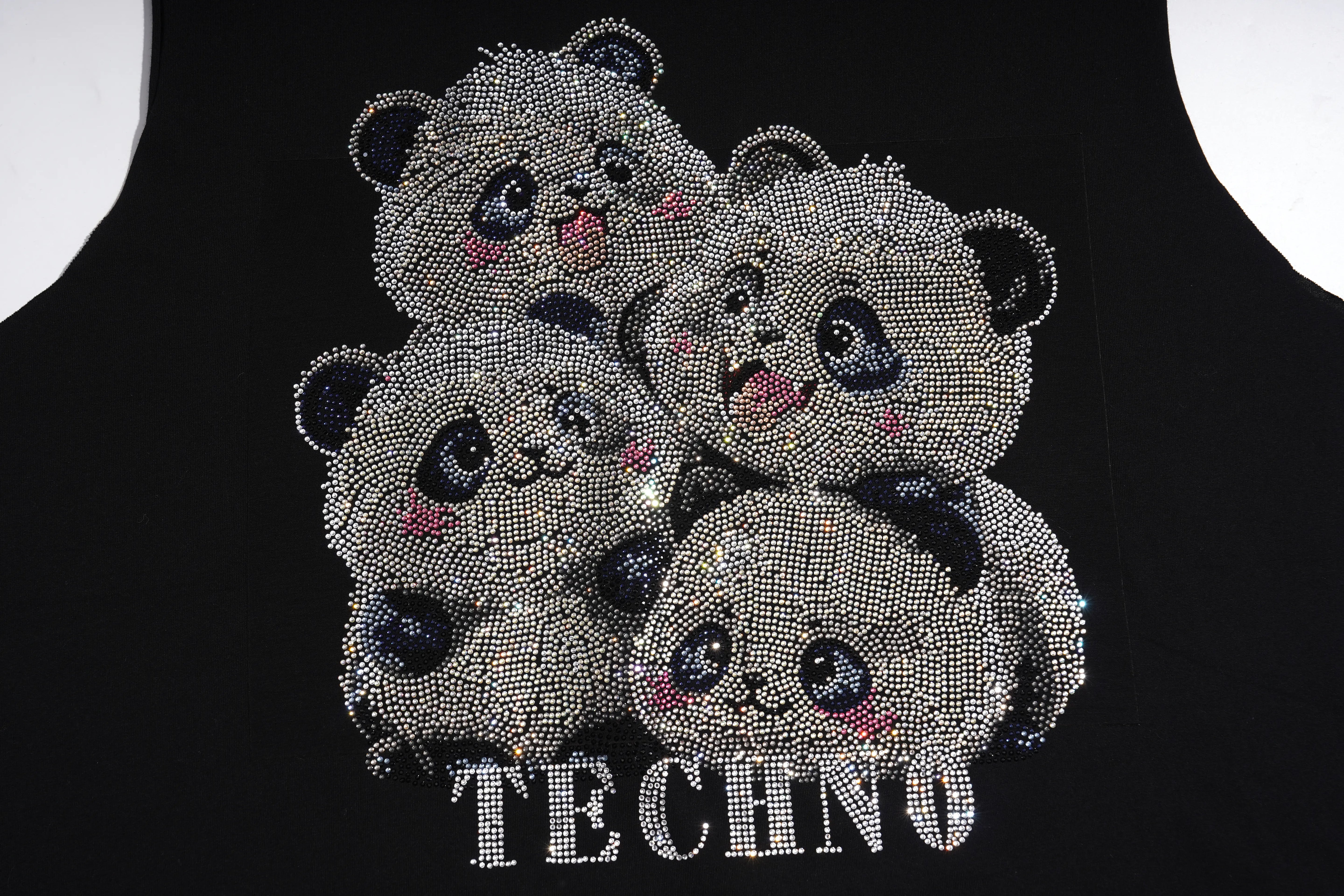 A black tank top featuring a large graphic of four cute panda faces and the word 'TECHNO' embellished with sparkling silver rhinestones. TCH Rhinestone Panda Graphic Sleeveless T-Shirt