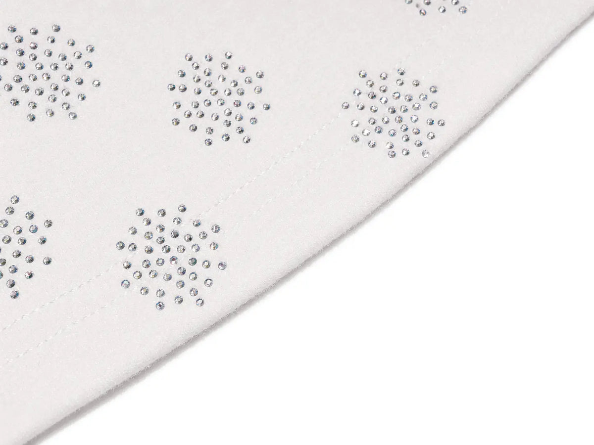 A close-up of a white fabric surface with repeated small silver rhinestone clusters arranged in a pattern, shown against a white background. TCH Rhinestone Pattern Long Sleeve Top