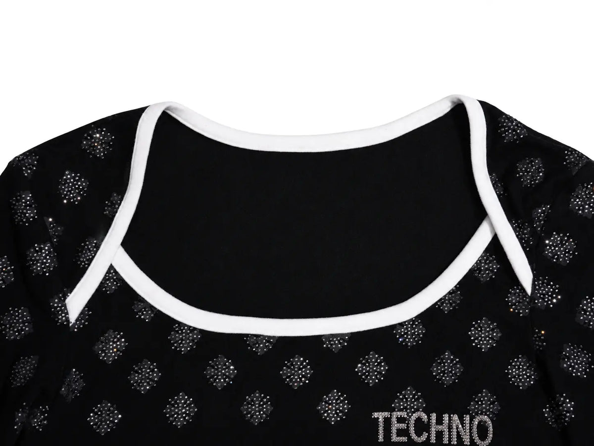 Close-up of a black garment with a scoop neckline, white trim, and small silver rhinestone patterns. The word 'TECHNO' is printed in white near the lower right. TCH Rhinestone Pattern Long Sleeve Top