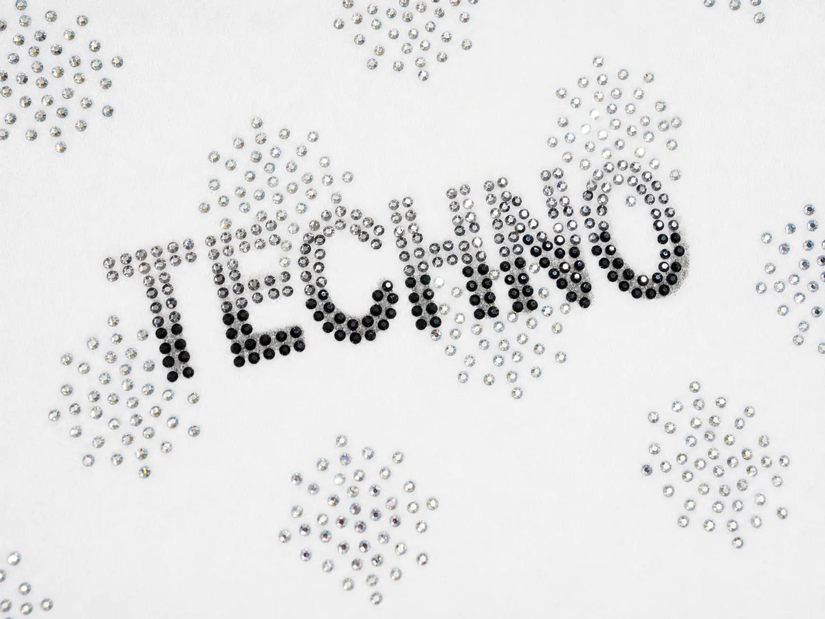 The word 'TECHNO' is spelled out in black rhinestones, surrounded by scattered clear and silver rhinestones on a white background. TCH Rhinestone Pattern Long Sleeve Top