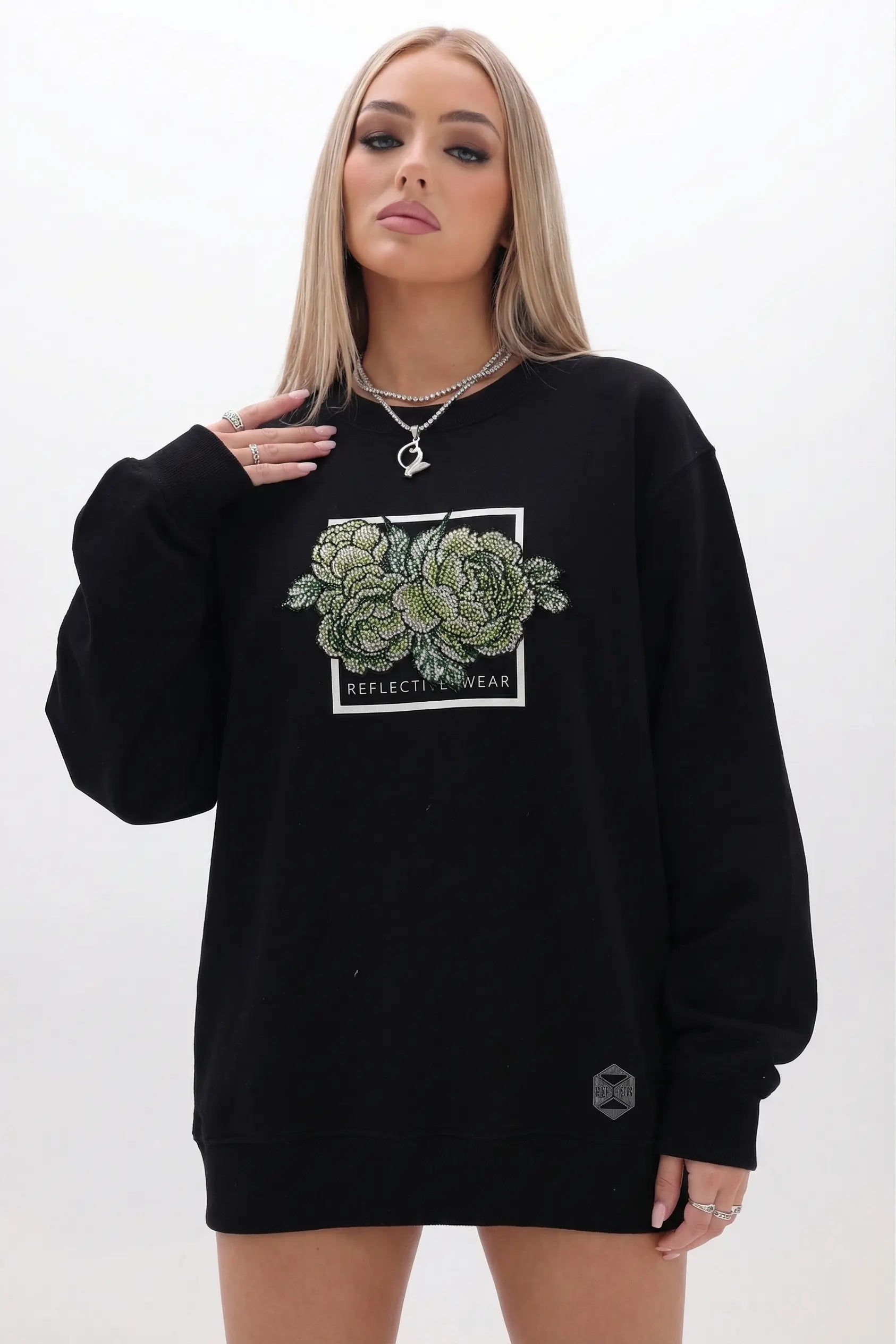 Person wearing a black sweatshirt with a succulent design on a white background, TCH Rhinestone Peony Sweatshirt