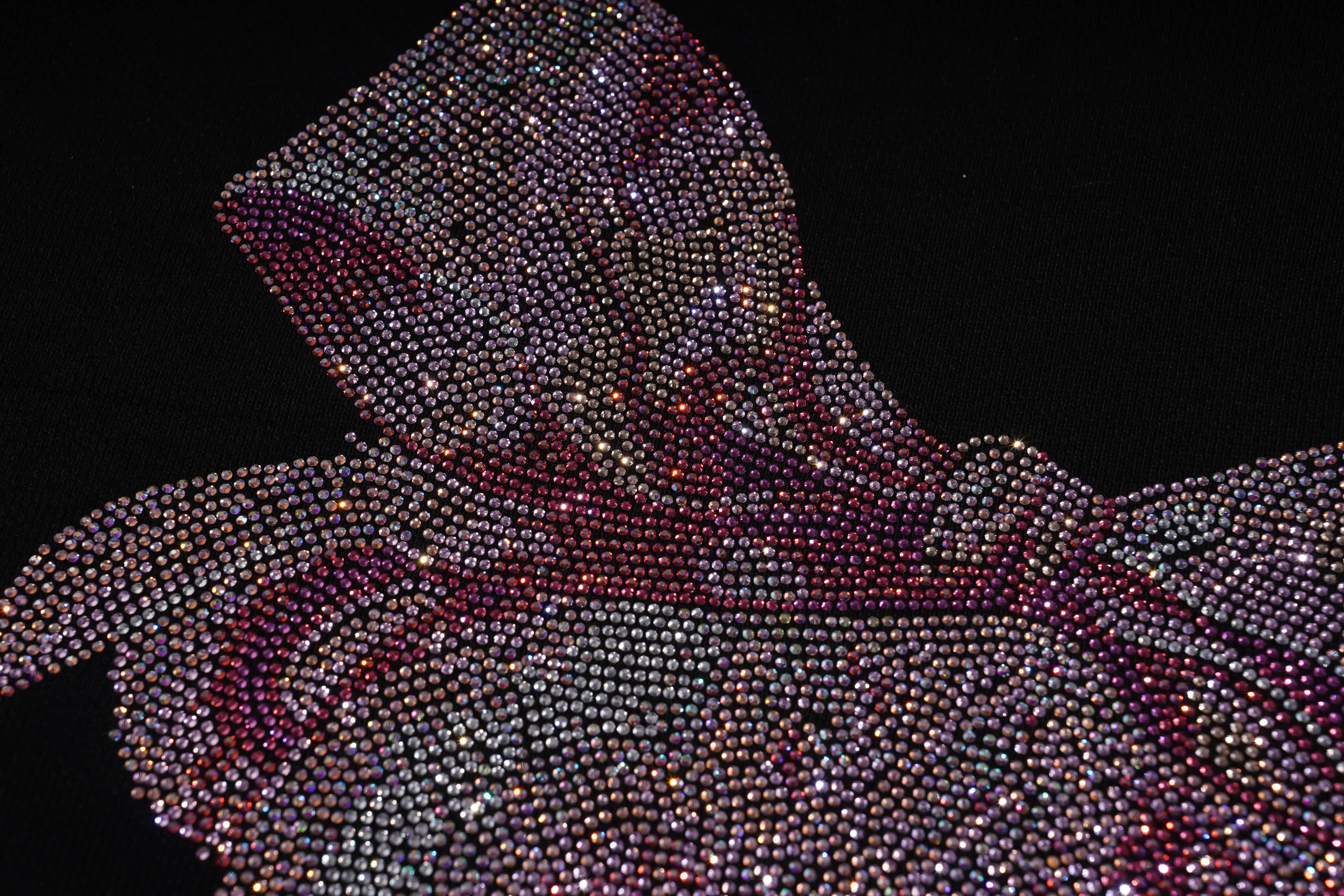 Close-up of a rhinestone-encrusted hooded garment on a black background, TCH Rhinestone Pink Bear Skull Sleeve Sweatshirt
