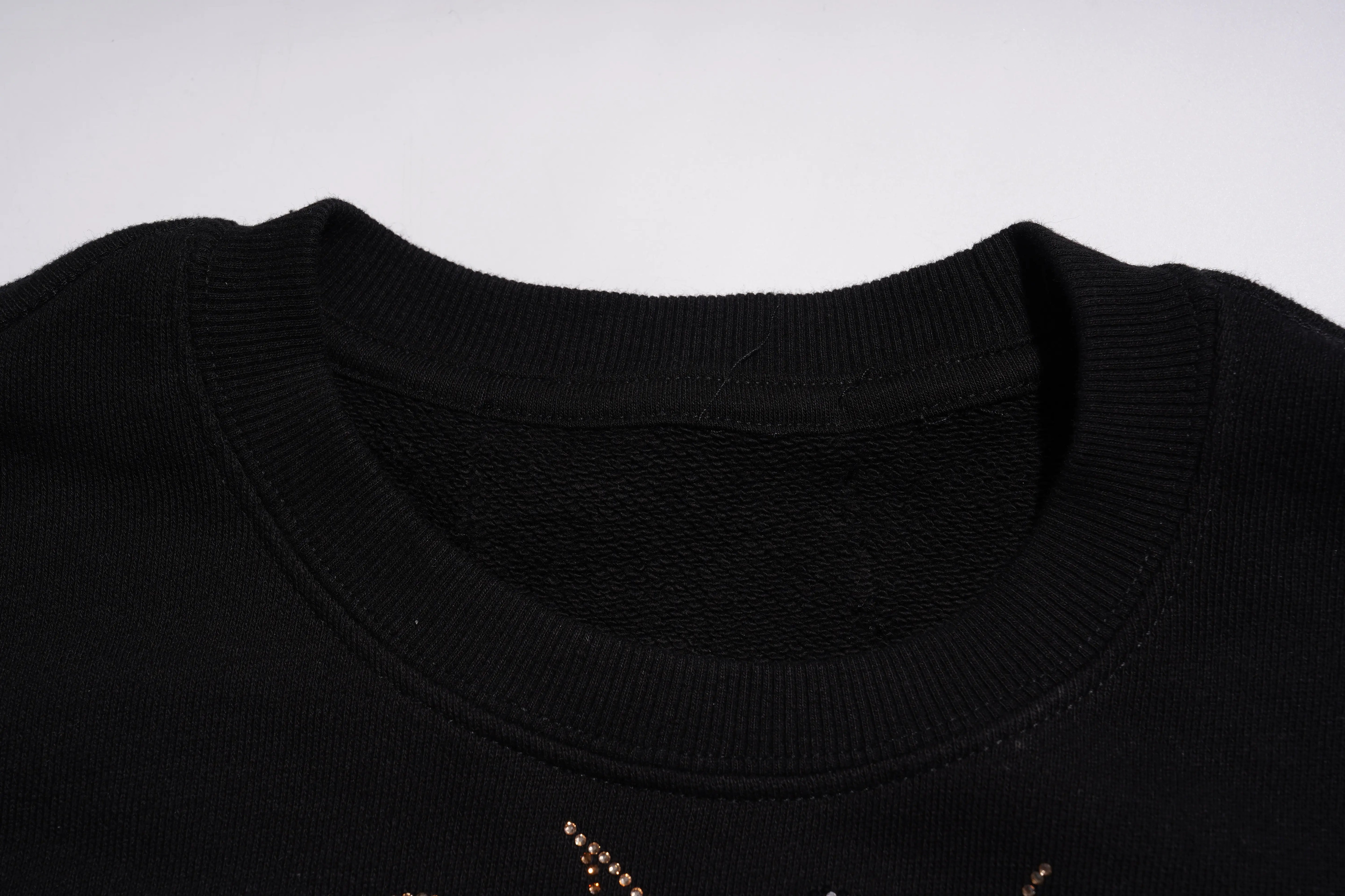 Close-up of a black sweater collar with gold embroidery on a white background, TCH Rhinestone Puppy Black Streetwear Sweatshirt