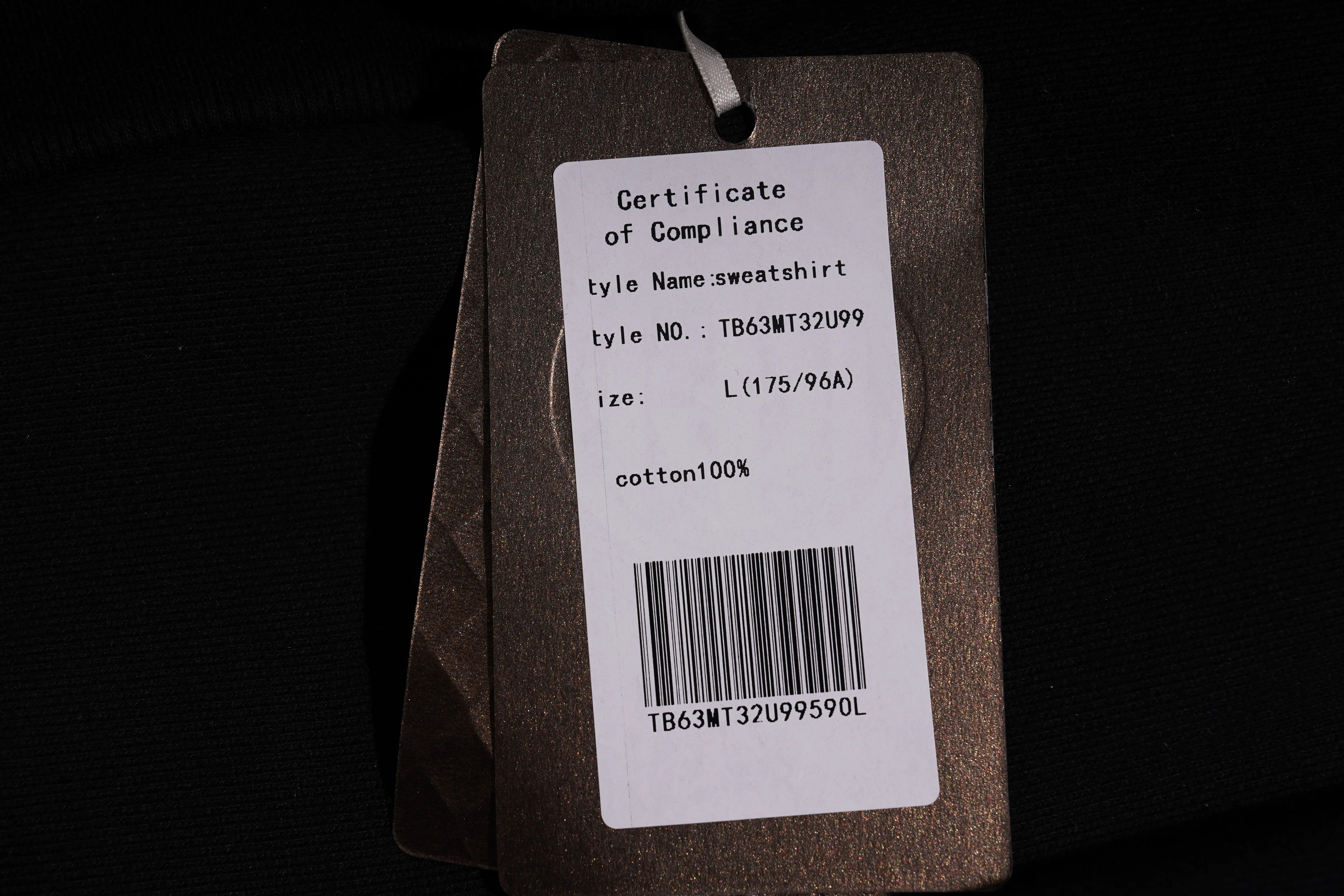 Product tag with certificate of compliance details on a dark background TCH Rhinestone Puppy Graphic Sweatshirt-1