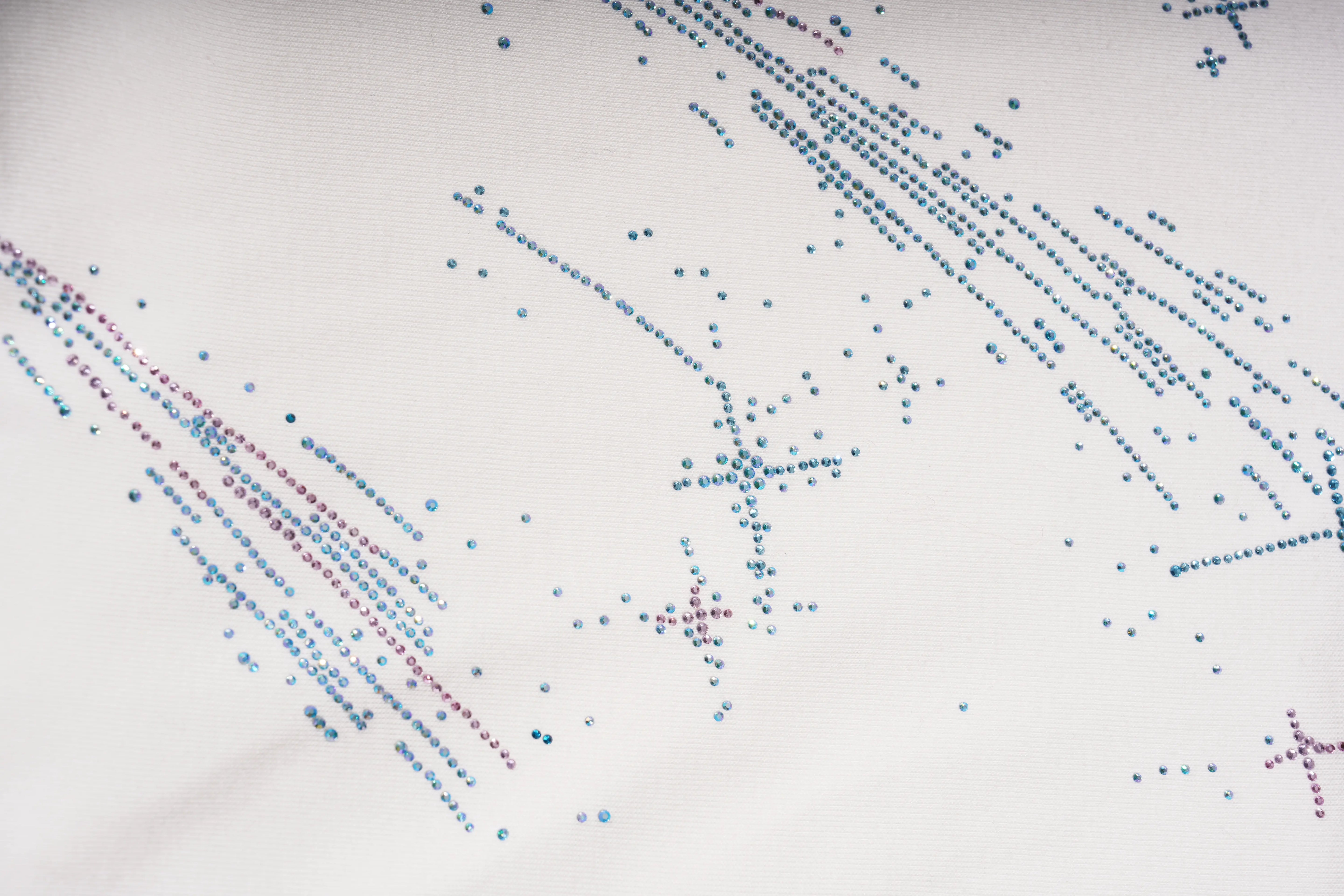 Close-up of a spider web with blue and red dots on a white background
