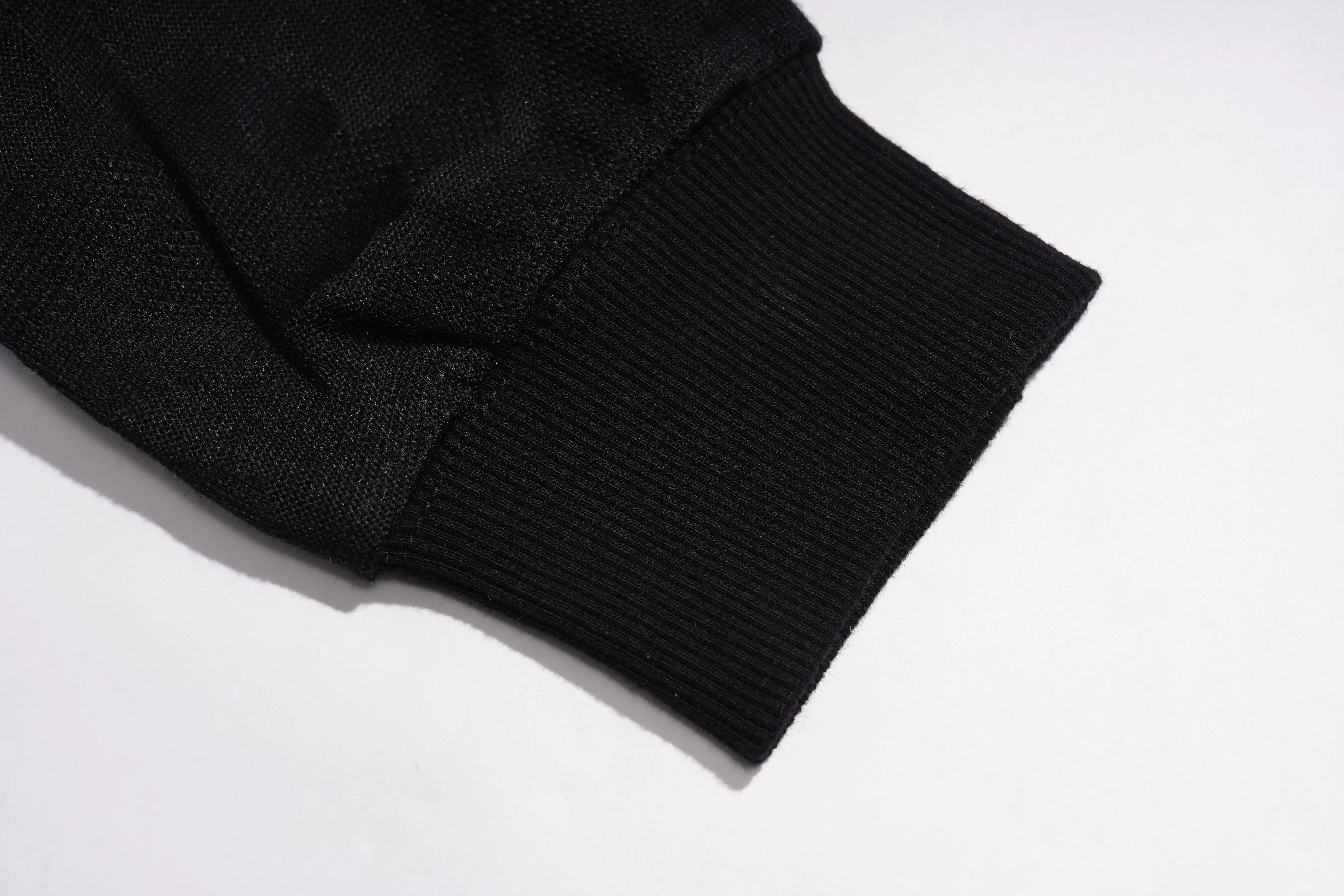 Close-up of a black knit sweater sleeve on a white background, TCH Rhinestone Snake Black Crewneck Sweatshirt