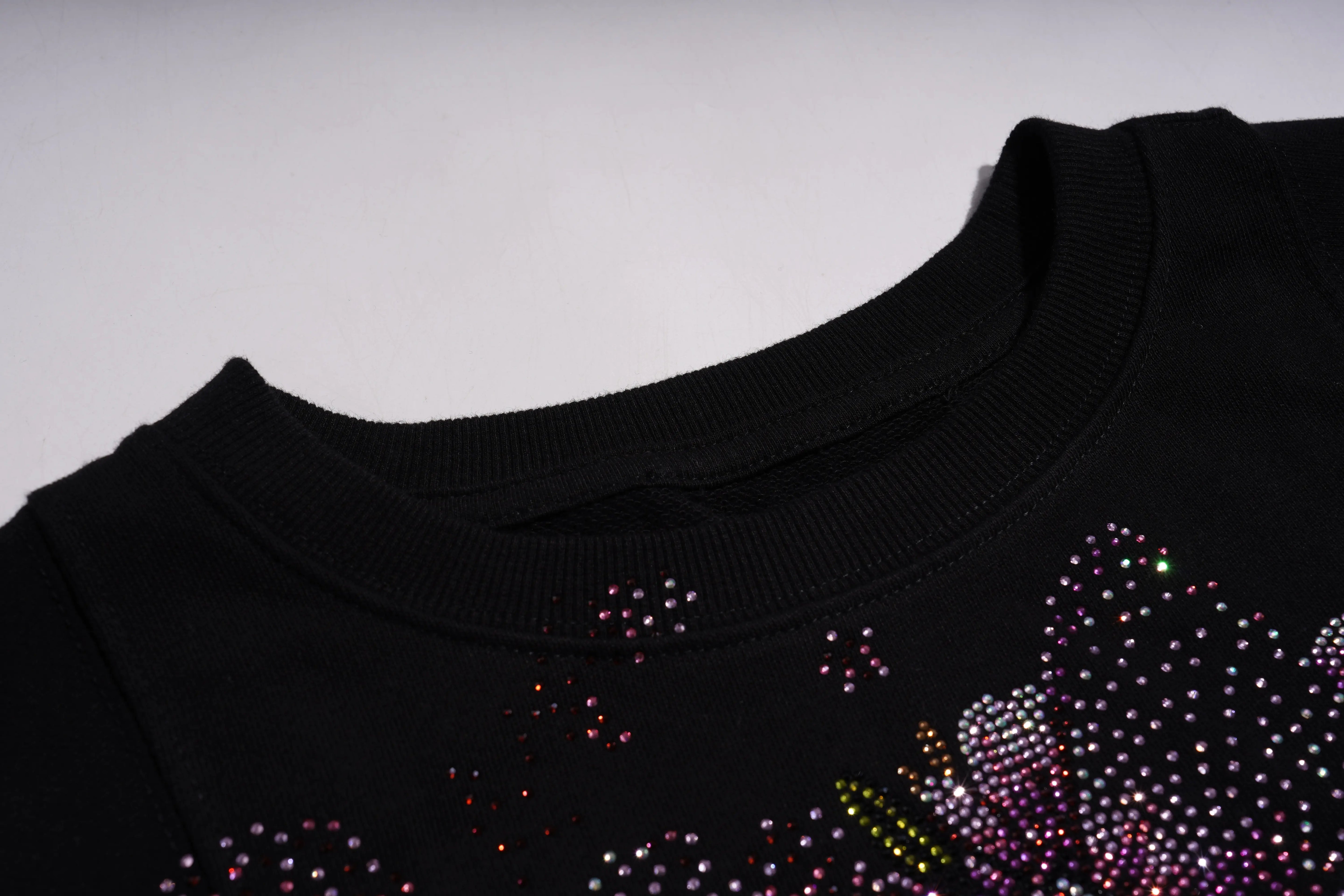 Black garment with colorful rhinestone embellishments on a light gray background, TCH Rhinestone Snake Eagle Sweatshirt Luxury Streetwear Brand Official Showcase