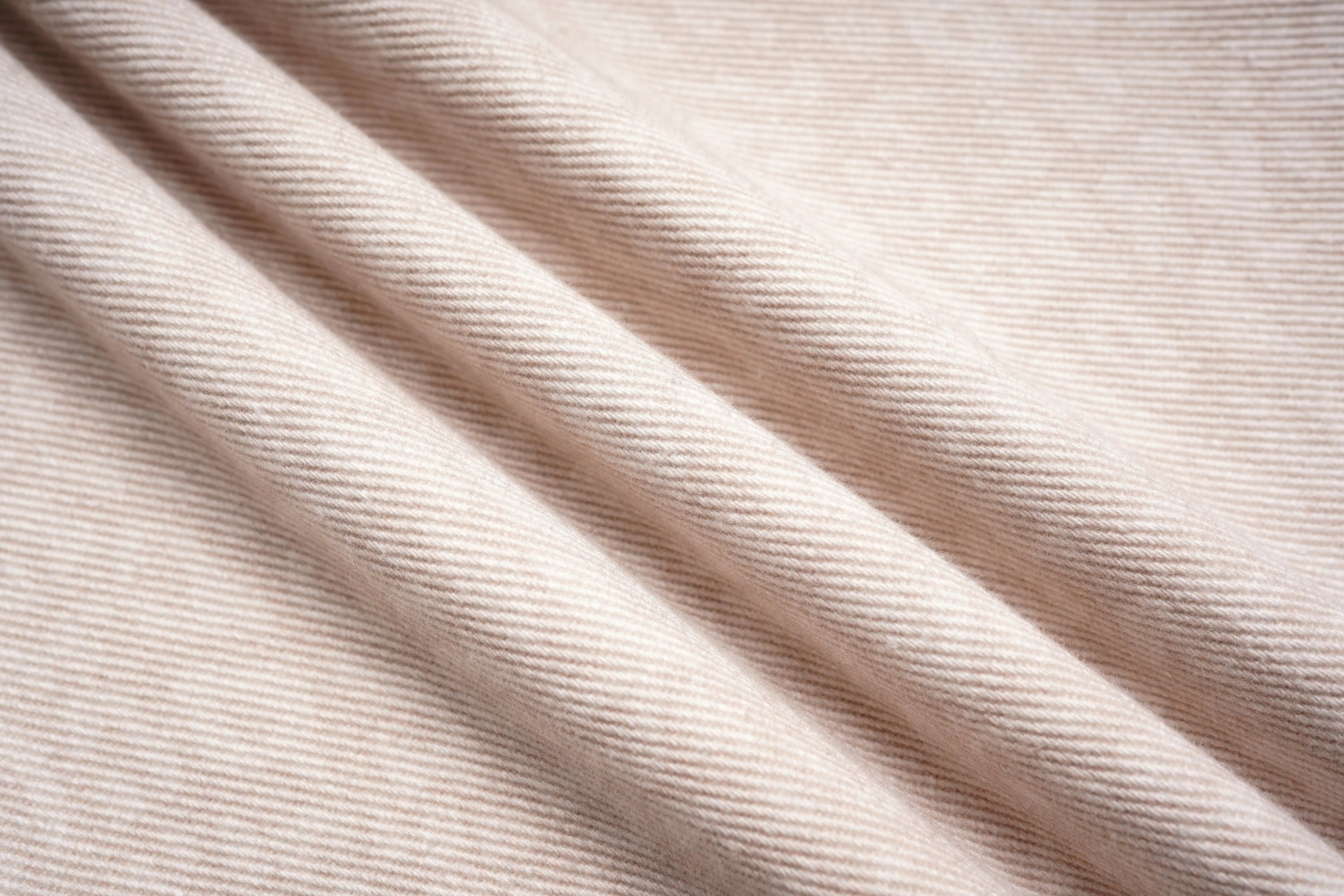 Close-up of beige fabric with visible texture, TCH Rhinestone Star & Angel Wings Beige Denim Jeans