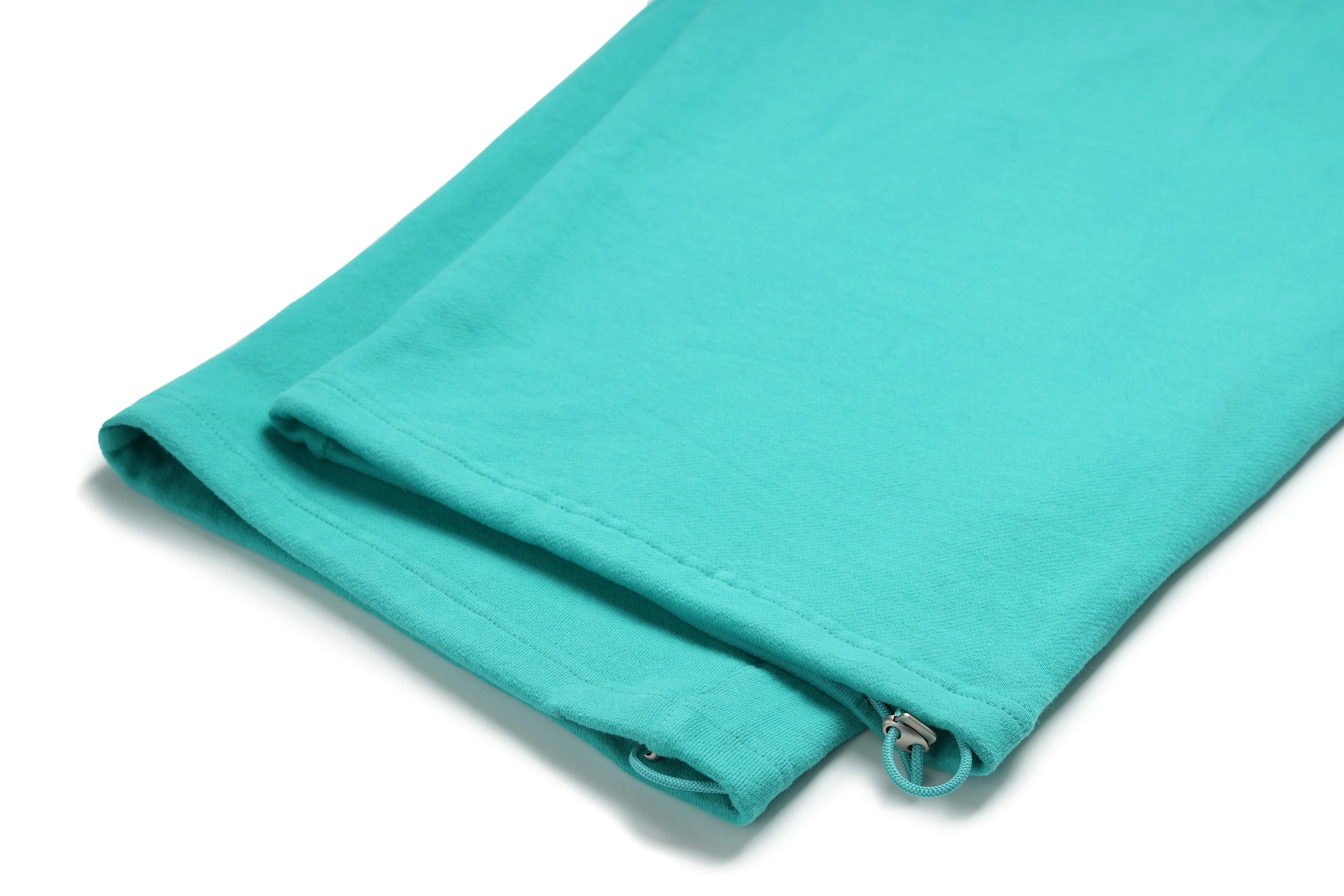 Turquoise fabric with a zipper on a white background, TCH Rhinestone “Tchmuch” Logo & Wings Teal Zip Tracksuit Set