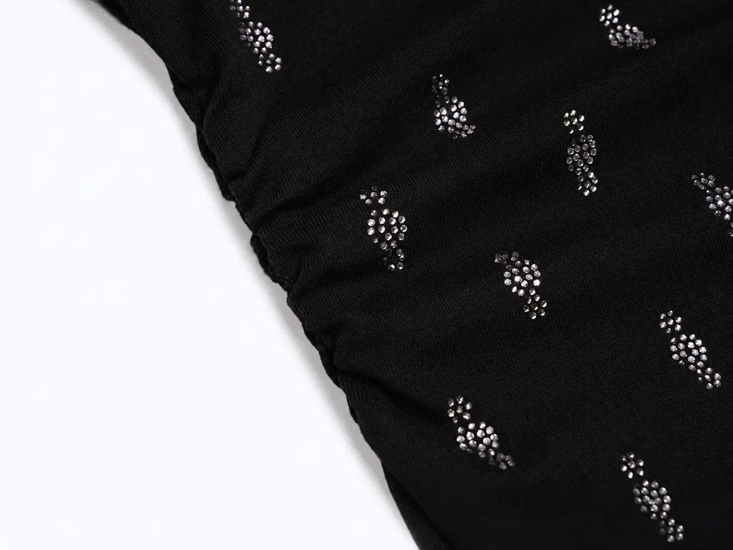 Close-up of a black fabric with a gathered elasticized edge and small repeating silver rhinestone embellishments, shown against a white background. TCH Rhinestone Techno Cross Graphic Black T-Shirt